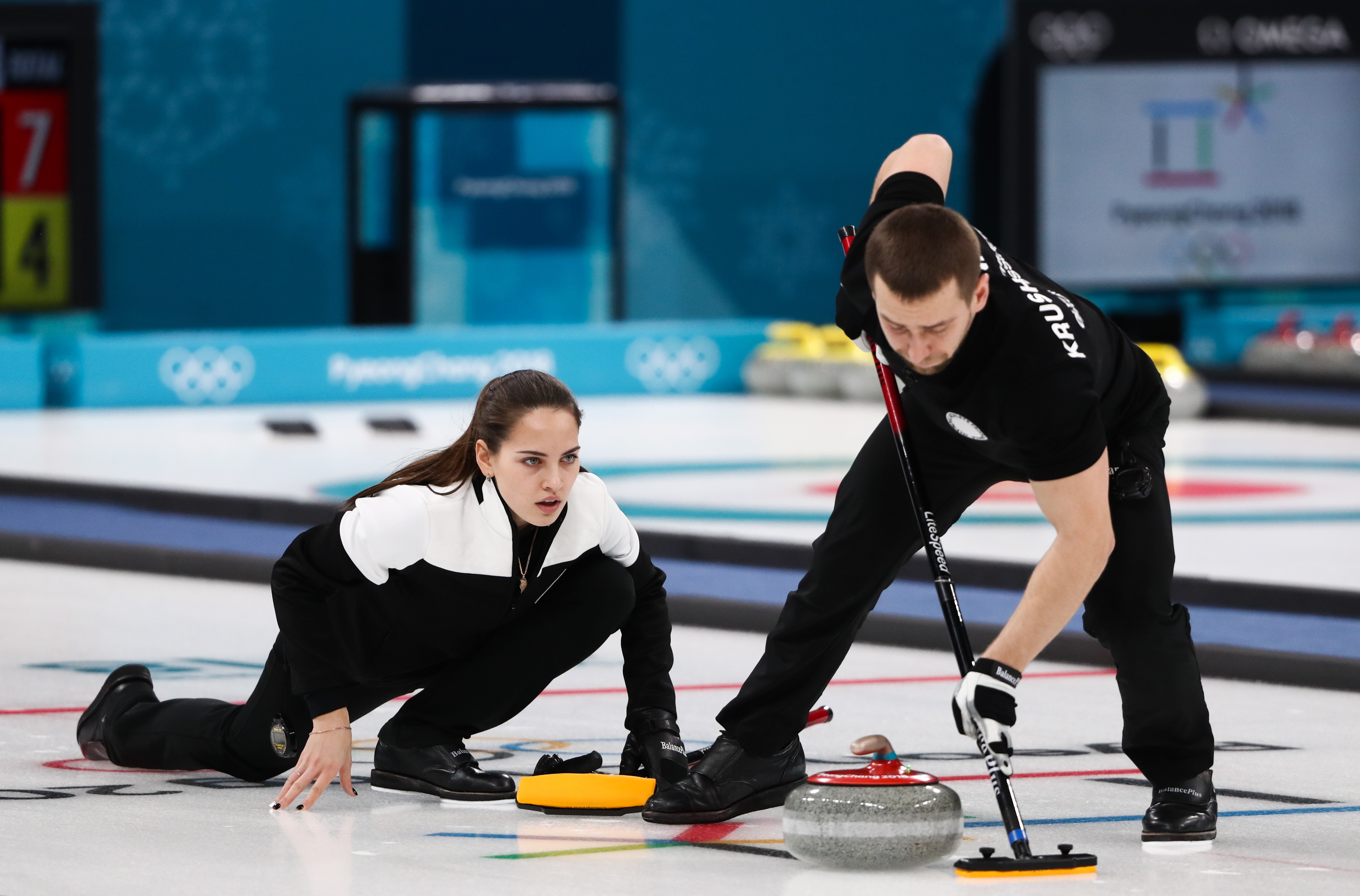 Curlers Alexander Krushelnitsky (R) and Anastasia Bryzgalova, Olympic Athletes from Russia, in their mixed doubles curling bronze medal match against Norway's Kristin Skaslien and Magnus Nedregotten during the 2018 Winter Olympic Games, at the Gangneung Curling Centre. (Valery Sharifulin—Valery Sharifulin/TASS)