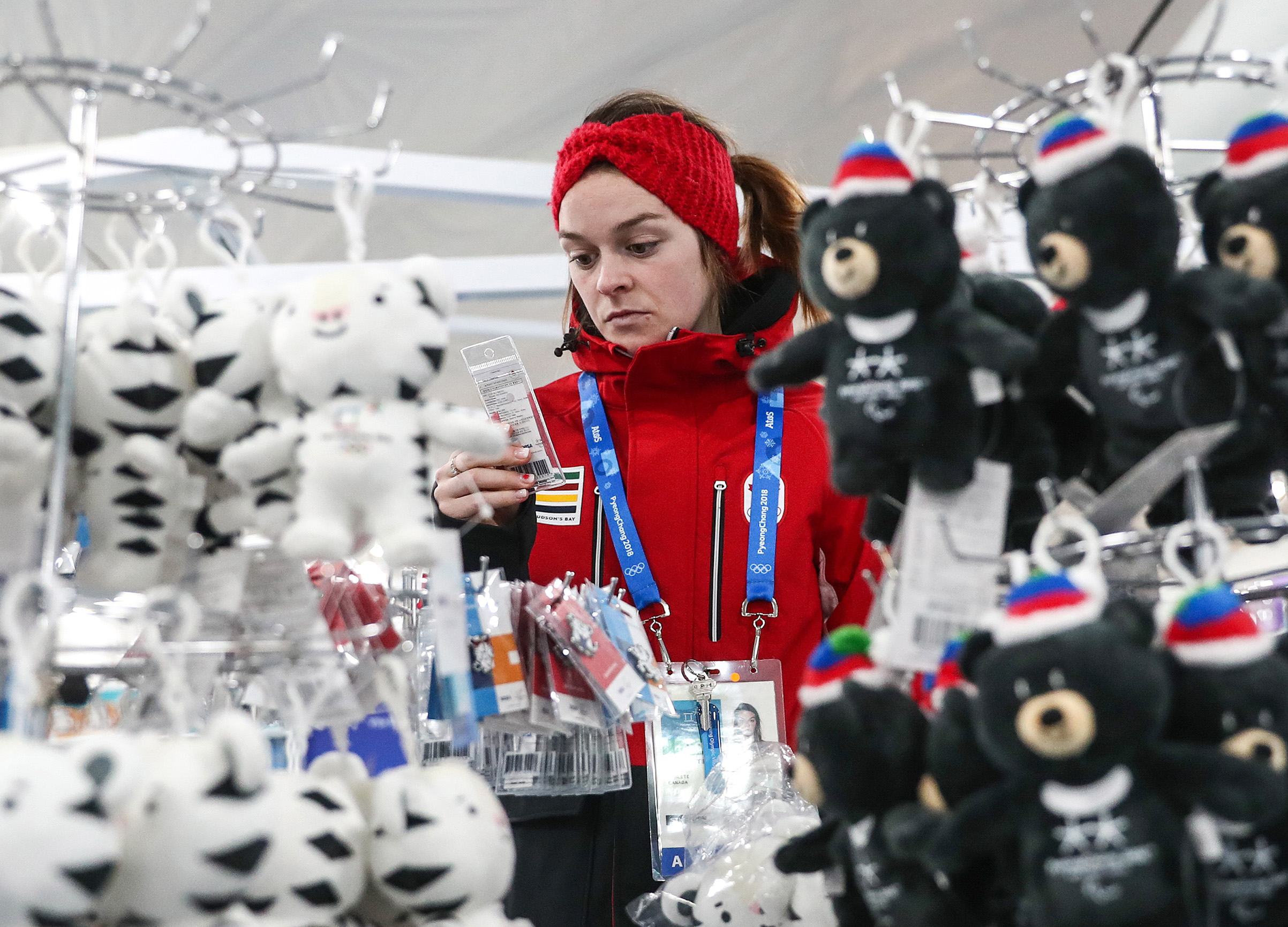 A girl seen by suffed toys of Soohorang and Bandabi, the official mascots of the 23rd Winter Olympic Games and the 12th Winter Paralympic Games in Pyeongchang respectively, on sale in the Olympic Village ahead of the 2018 Winter Olympic Games. (Valery Sharifulin—TASS/Getty Images)