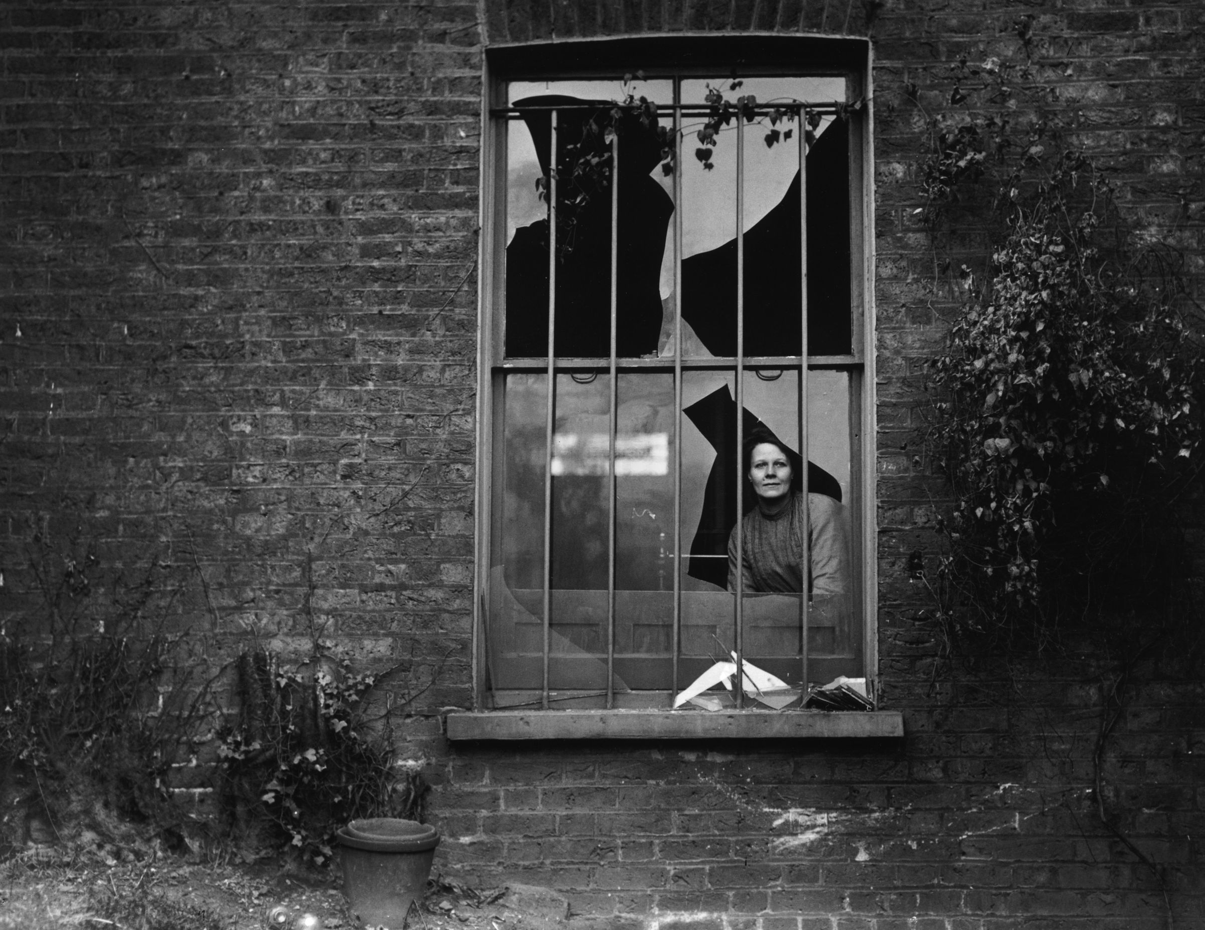 A woman peers through a shattered window the day after a bomb attack by suffragettes on nearby Holloway prison, Dec. 19, 1913. No-one was arrested for the attack, but suspicion fell on the Women's Social and Political Union (WSPU). (Topical Press Agency / Getty Images)