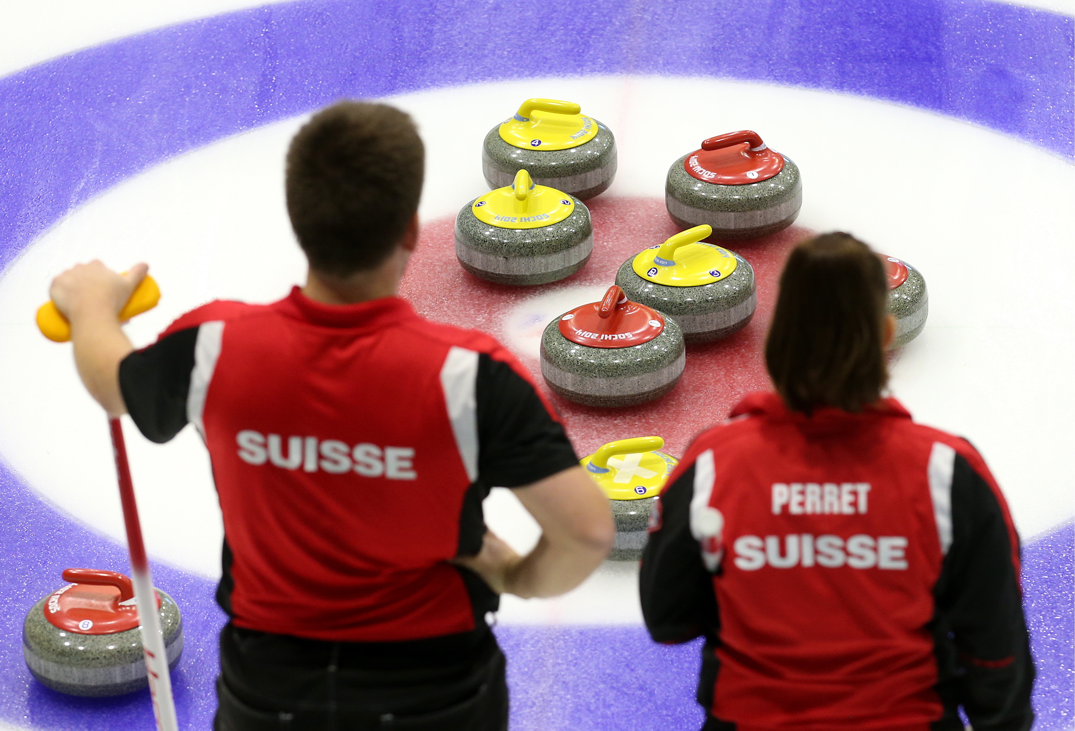 Martin Rios (L) and Jenny Perret of Team Perret (Glarus, Switzerland) in a match against Team Moskaleva (Dmitrov, Russia) at International Mixed Doubles Sochi 2017, an event of the 2017-2018 World Mixed Doubles Curling Tour, at the Ice Cube Curling Center. (Photo by Valery Sharifulin—TASS/Getty Images:)