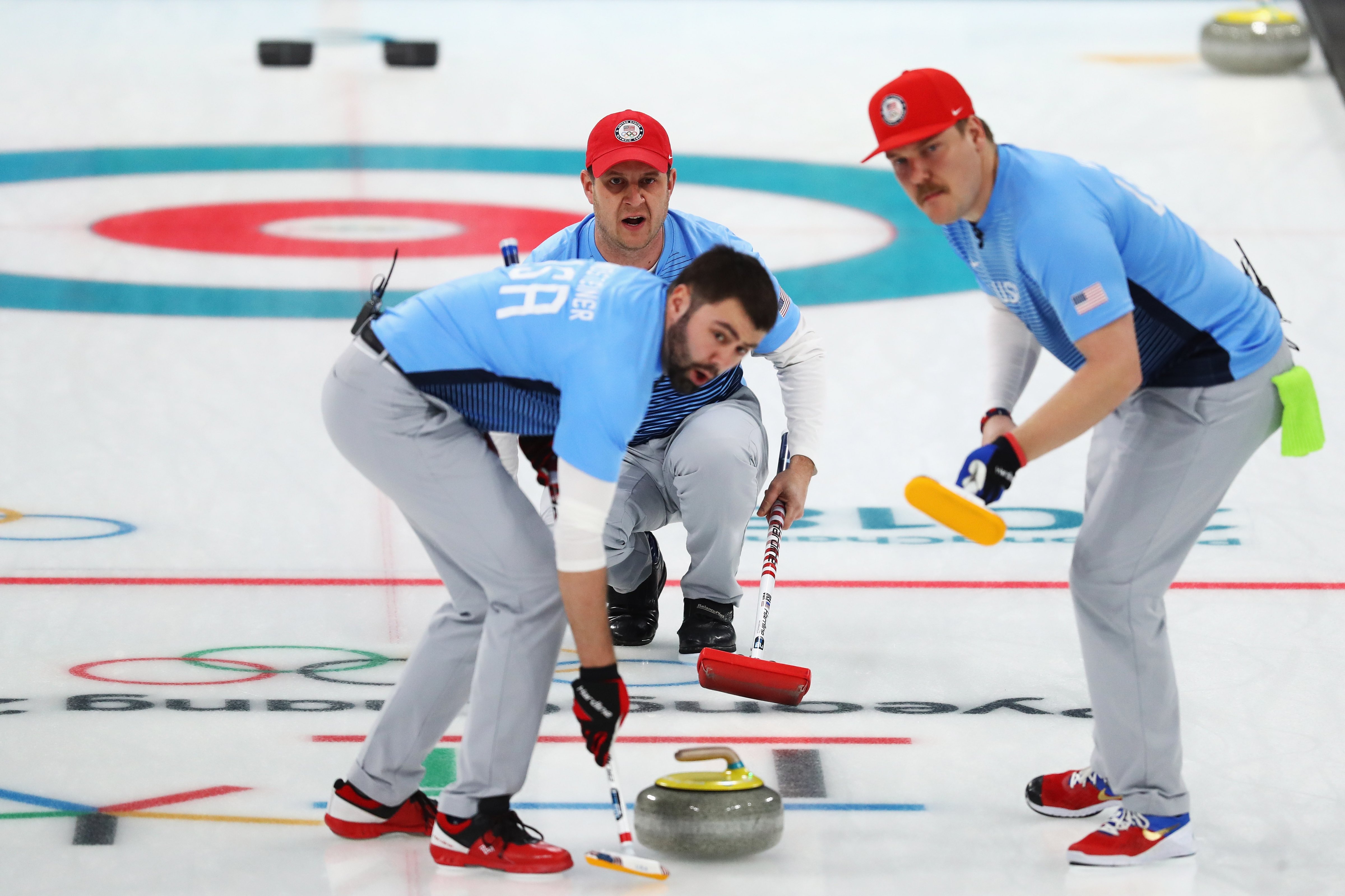 Matt Hamilton, John Shuster, John Landsteiner of USA compete in the Curling Men's Semi-final against Canada on day thirteen of the PyeongChang 2018 Winter Olympic Games at Gangneung Curling Centre on February 22, 2018 in Gangneung, South Korea. (Dean Mouhtaropoulos—Getty Images)
