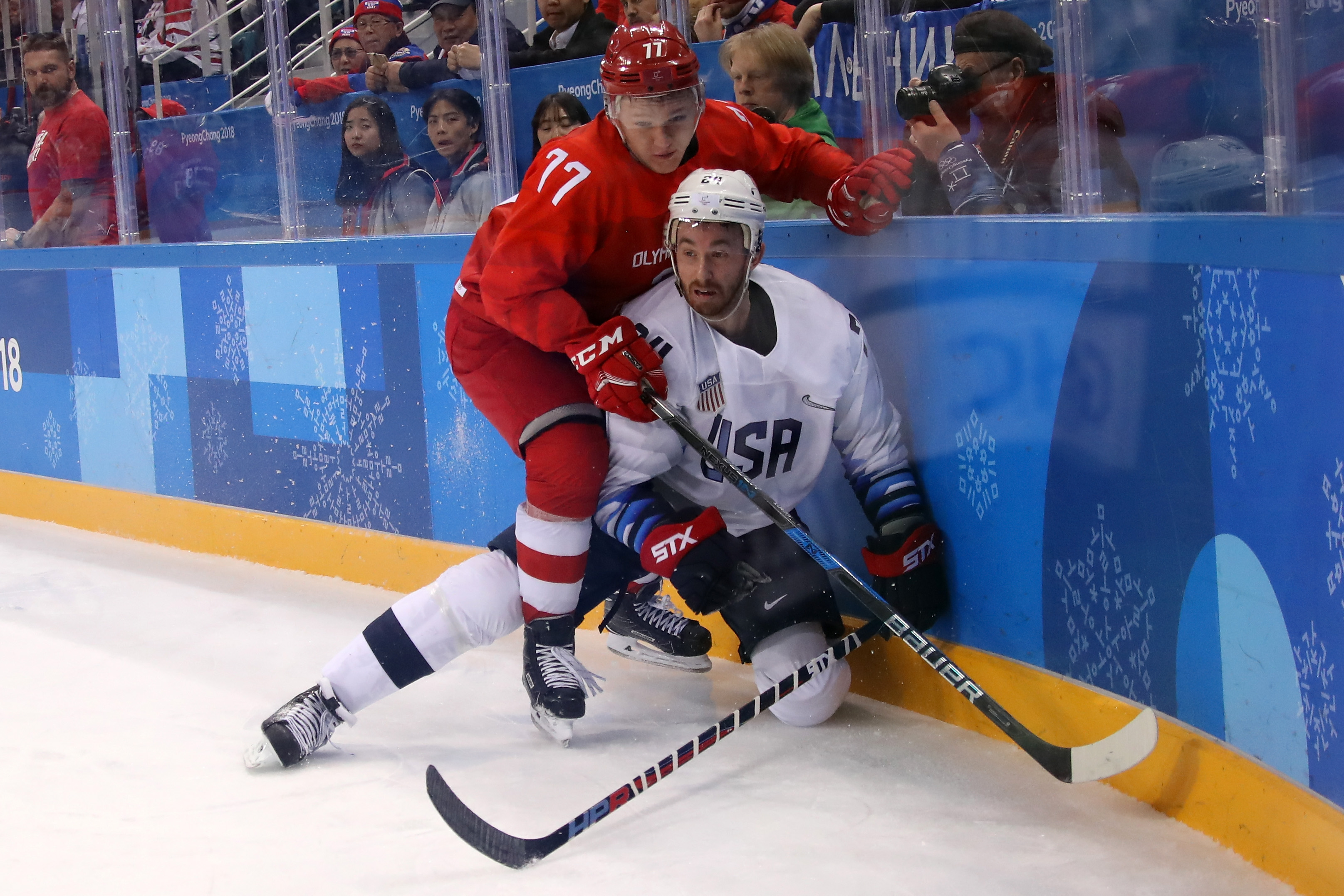 Jonathon Blum #24 of the United States gets knocked down against Kirill Kaprizov #77 of Olympic Athlete from Russia during the Men's Ice Hockey Preliminary Round Group B game on day eight of the PyeongChang 2018 Winter Olympic Games (Bruce Bennett – Getty Images)