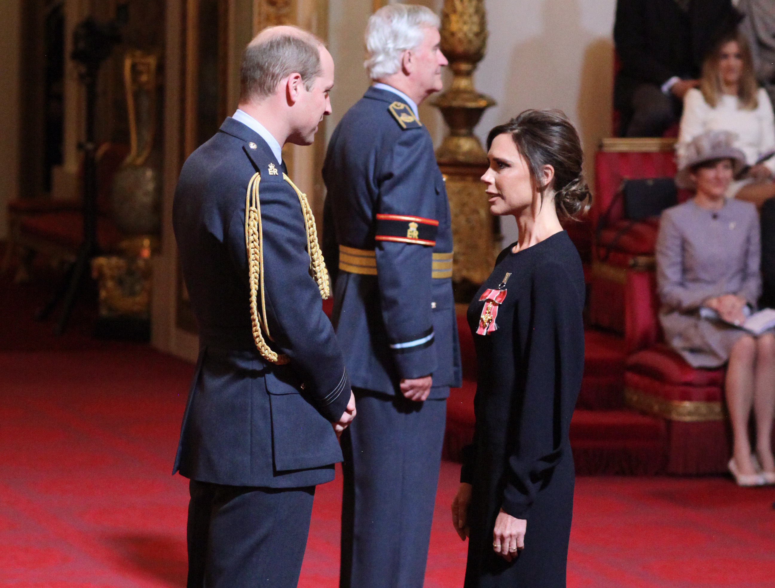 Victoria Beckham receives her OBE from the Duke of Cambridge during an investiture ceremony at Buckingham Palace in London. (Yui Mok - PA Images—PA Images via Getty Images)