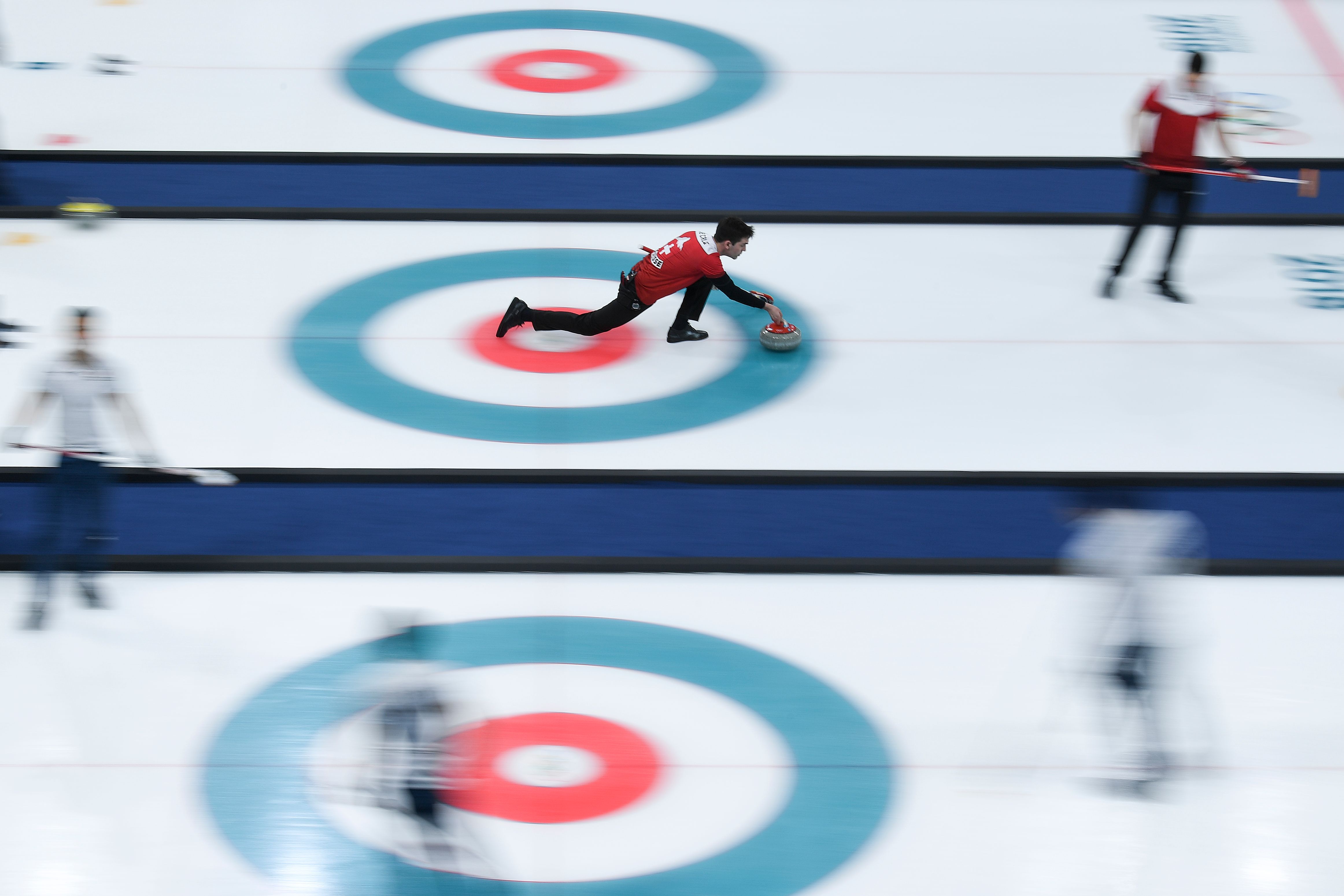 Switzerland's Peter De Cruz throws the stone during the curling men's round robin session between Switzerland and Italy during the Pyeongchang 2018 Winter Olympic Games at the Gangneung Curling Centre in Gangneung on February 14, 2018. (WANG ZHAO—AFP/Getty Images)