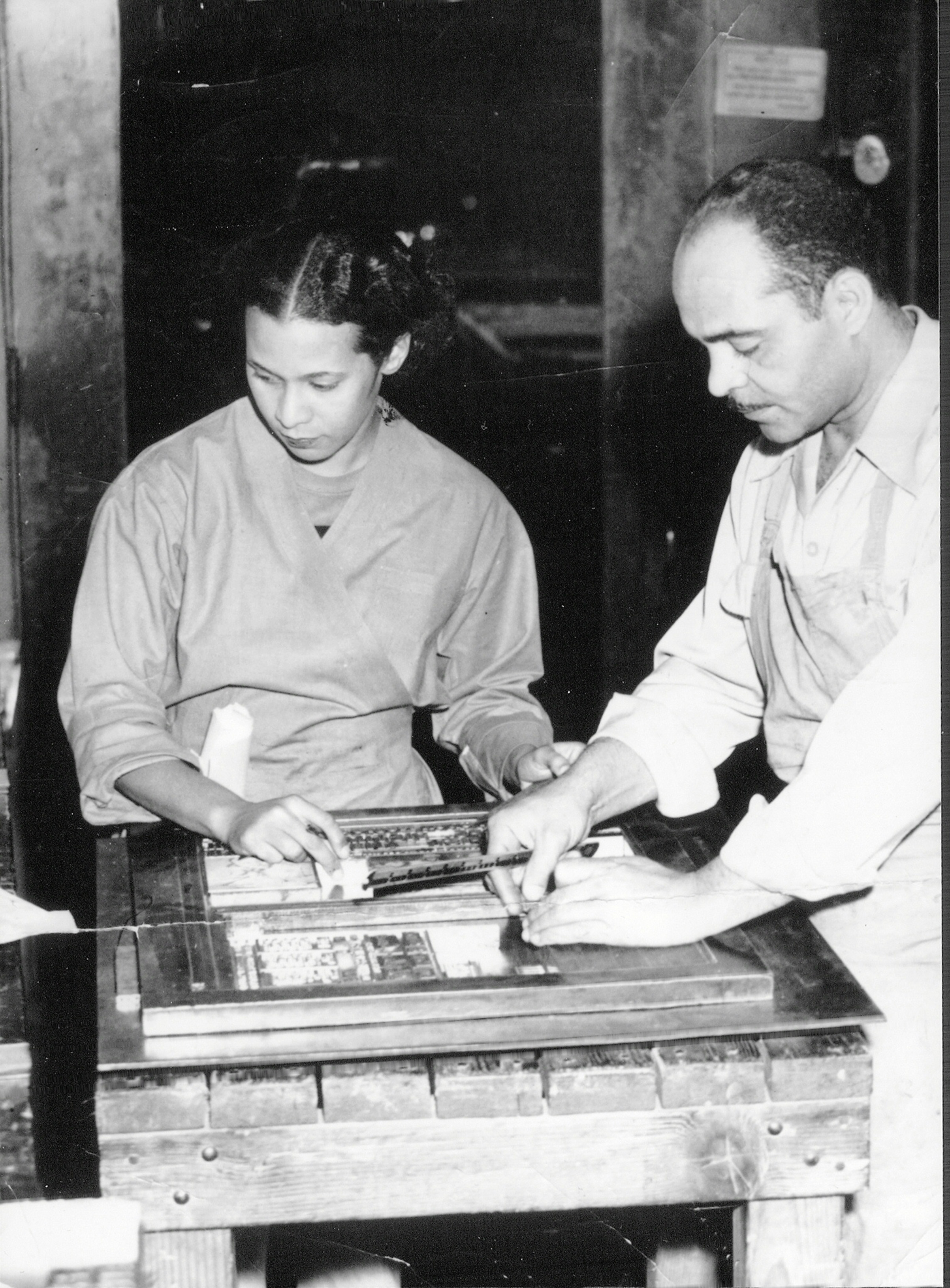 A circa 1950s photo of publishers of the Los Angeles <i>Tribune</i> Lucius and Almena Lomax, parents of Michael Lomax, setting the typeface to print the newspaper. (Courtesy of the Lomax Family)