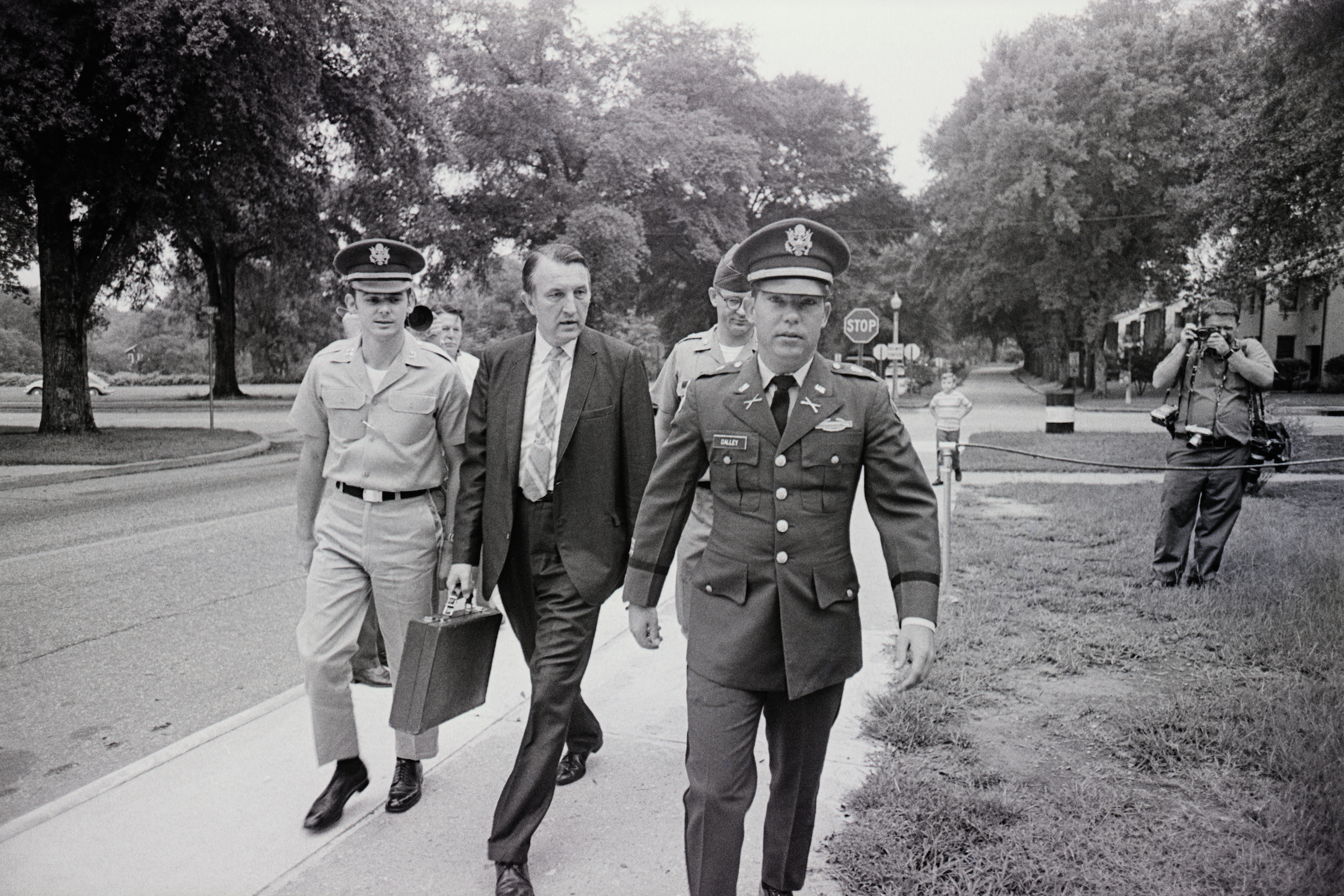 Lieutenant William Calley is flanked by an unidentified civilian assistant attorney (L) and an unidentified Army escort officer as he leaves a closed-door preliminary court martial hearing on Aug. 24, 1970, at Fort Benning, Ga. (Bettmann/Getty Images)