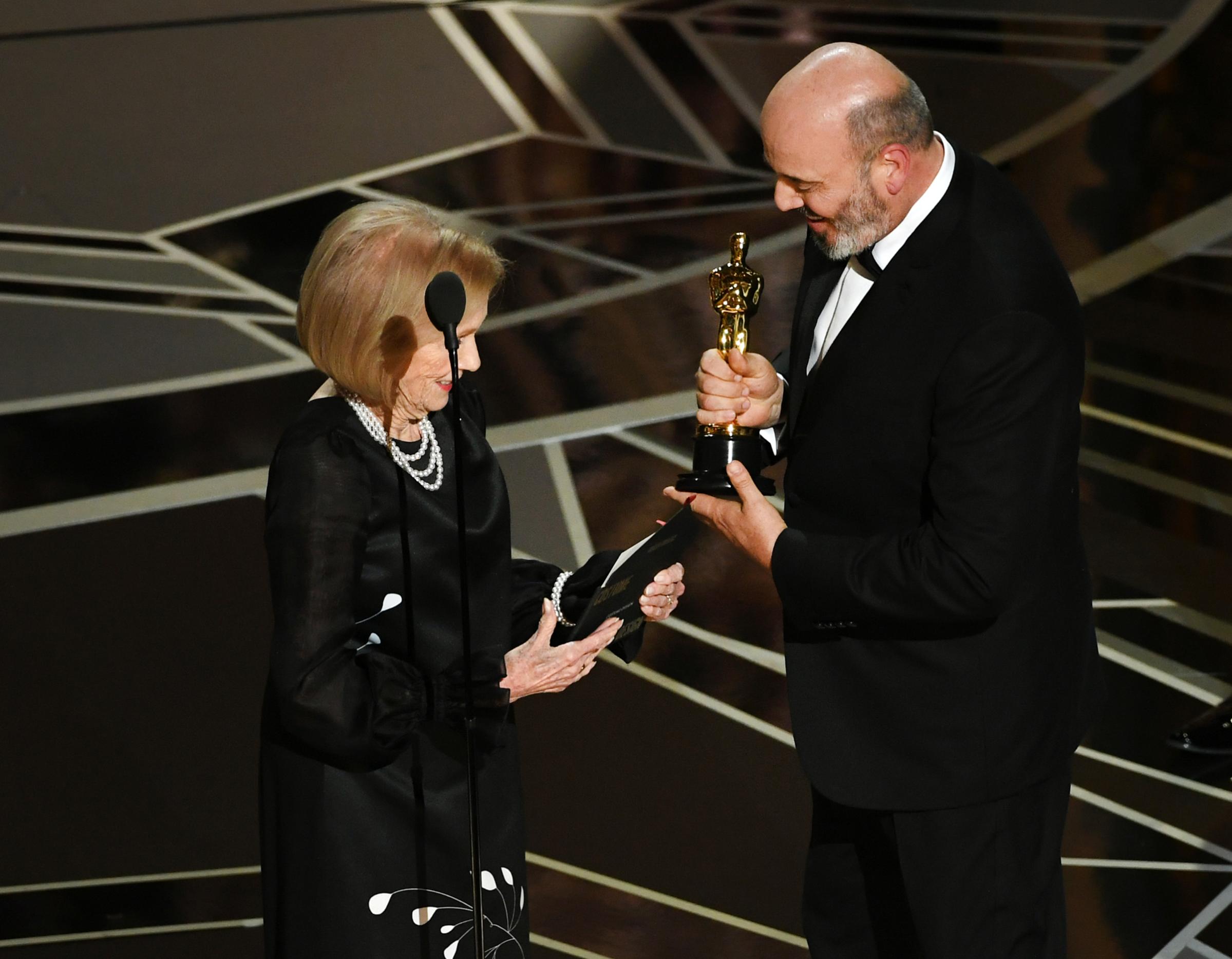 Costume designer Mark Bridges accepts Best Costume Design for 'Phantom Thread' from actor Eva Marie Saint onstage during the 90th Annual Academy Awards at the Dolby Theatre at Hollywood &amp; Highland Center on March 4, 2018 in Hollywood.