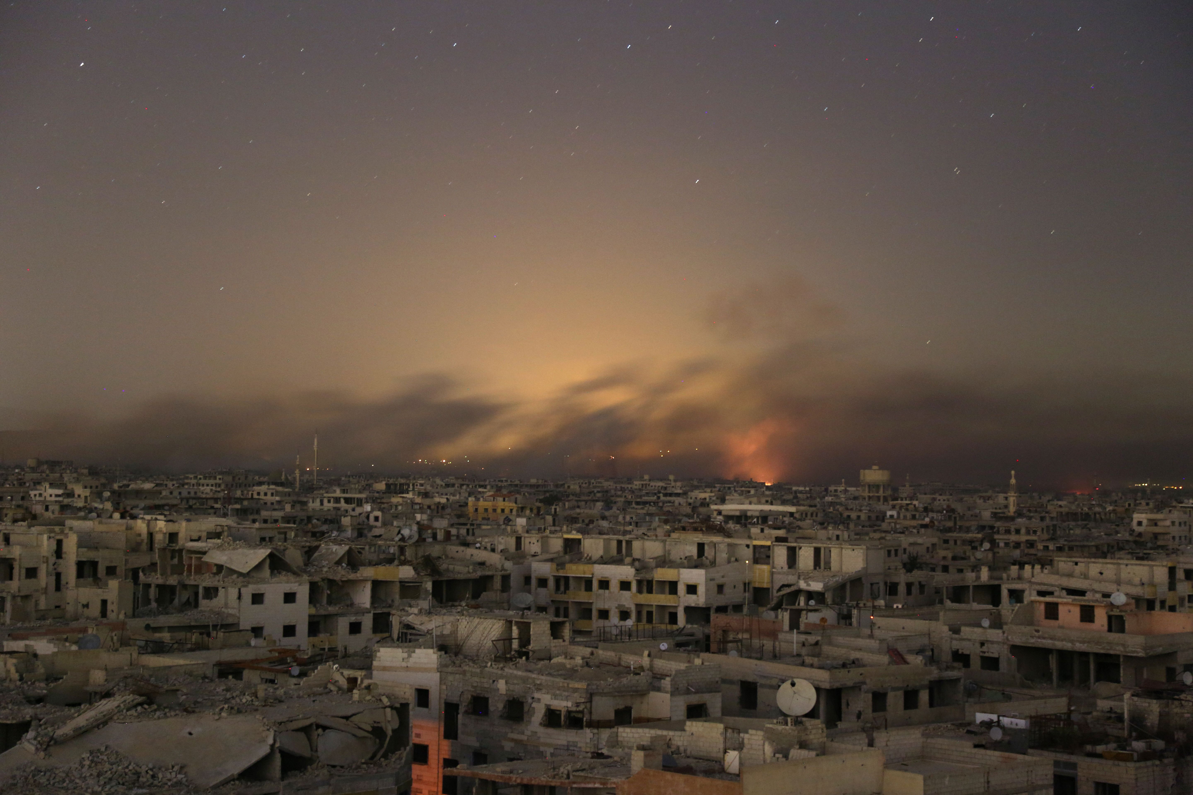 Smoke rises during Syrian government bombardment on the rebel-controlled town of Arbin, in the besieged Eastern Ghouta region on the outskirts of the capital Damascus, on late March 11, 2018. (Ammar Sulieman/AFP/Getty Images)