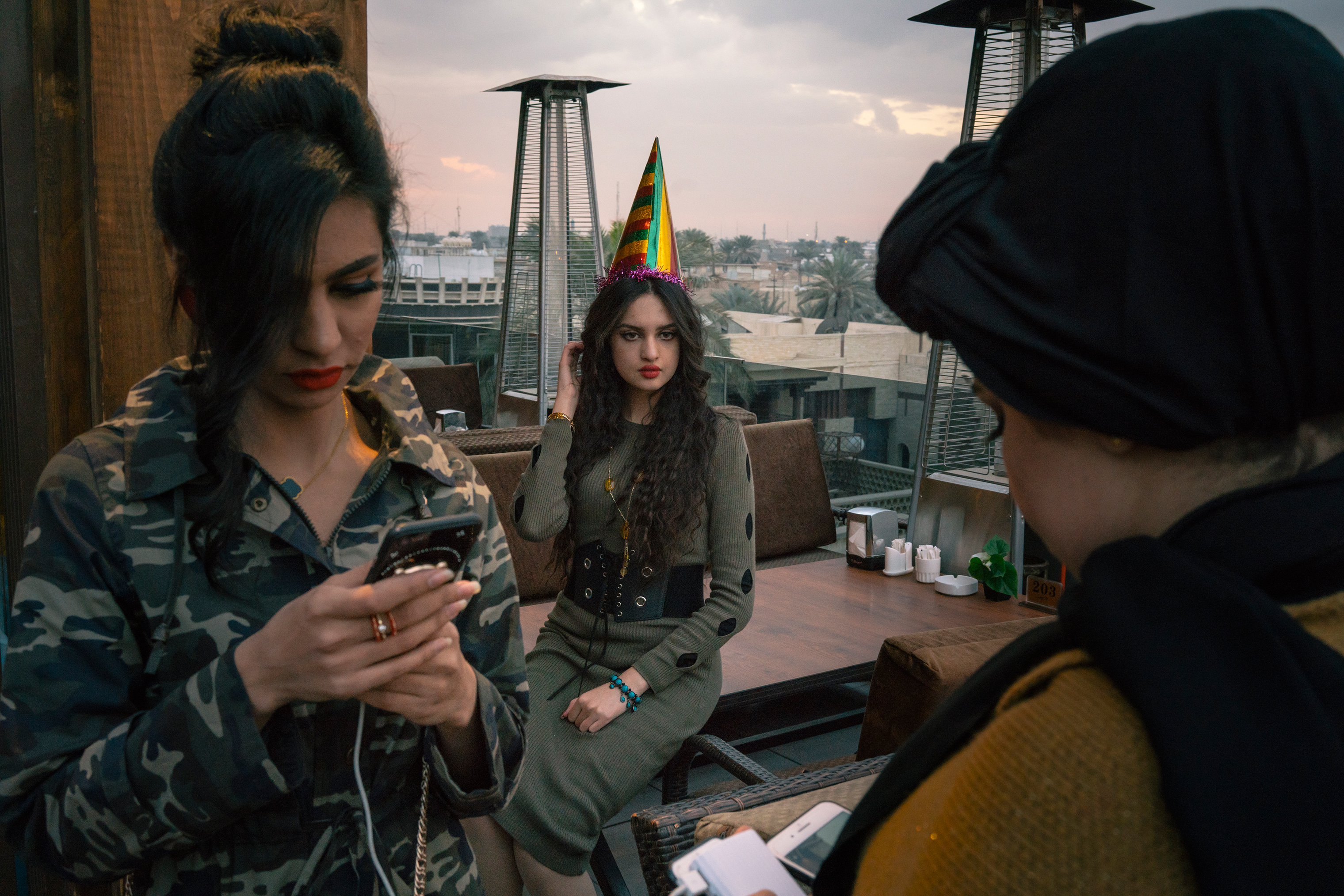 Nariman Abujahar, center, a computer engineering student, celebrates her 23rd birthday with friends on a restaurant’s rooftop terrace in the Mansour district of Baghdad on Jan. 27. (Emanuele Satolli for TIME)