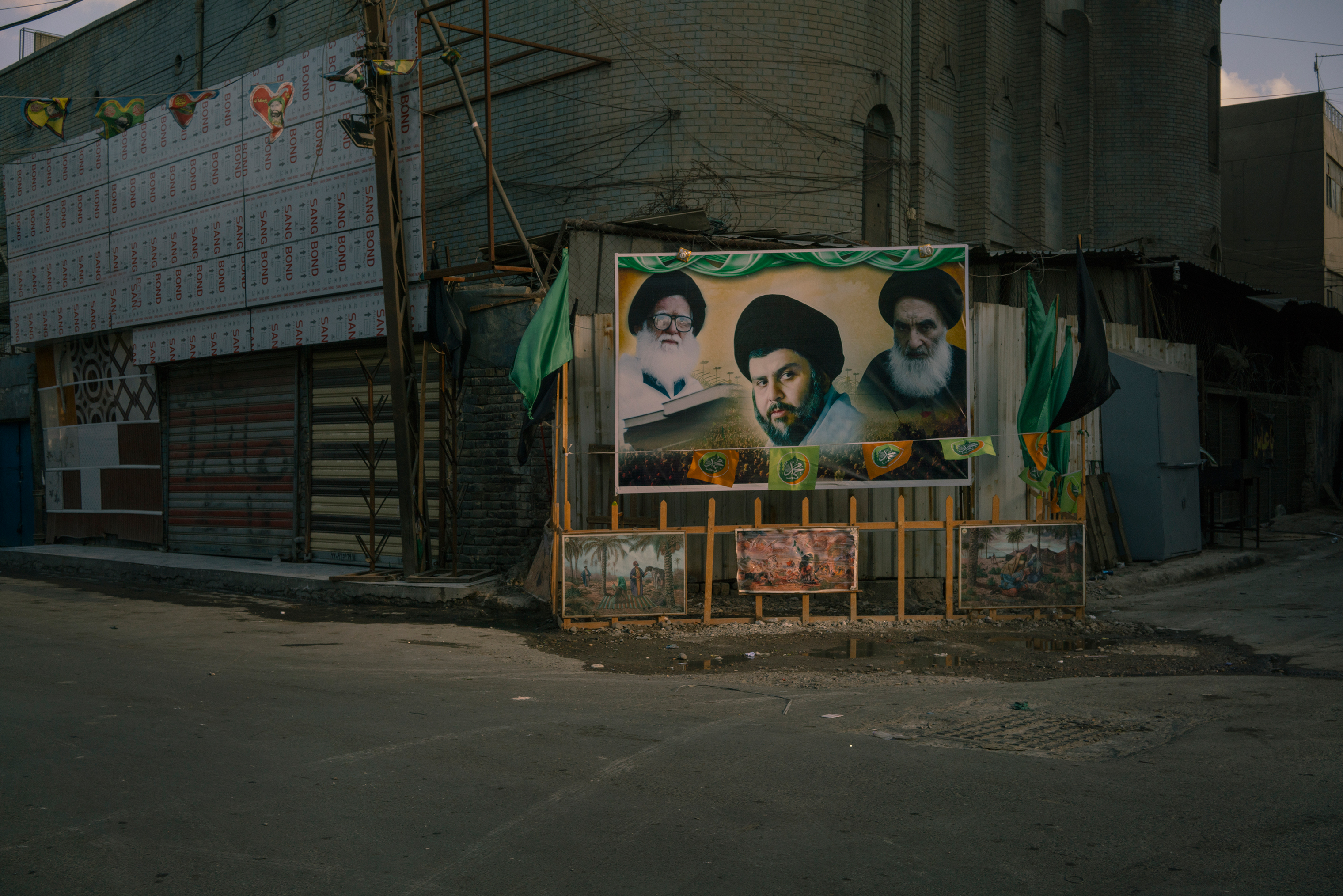 A billboard in Baghdad on Jan. 28 shows portraits of Shi‘ite spiritual leaders, from left, Mohammad Sadeq al-Sadr, Muqtada al-Sadr and Ali al-Sistani. (Emanuele Satolli for TIME)