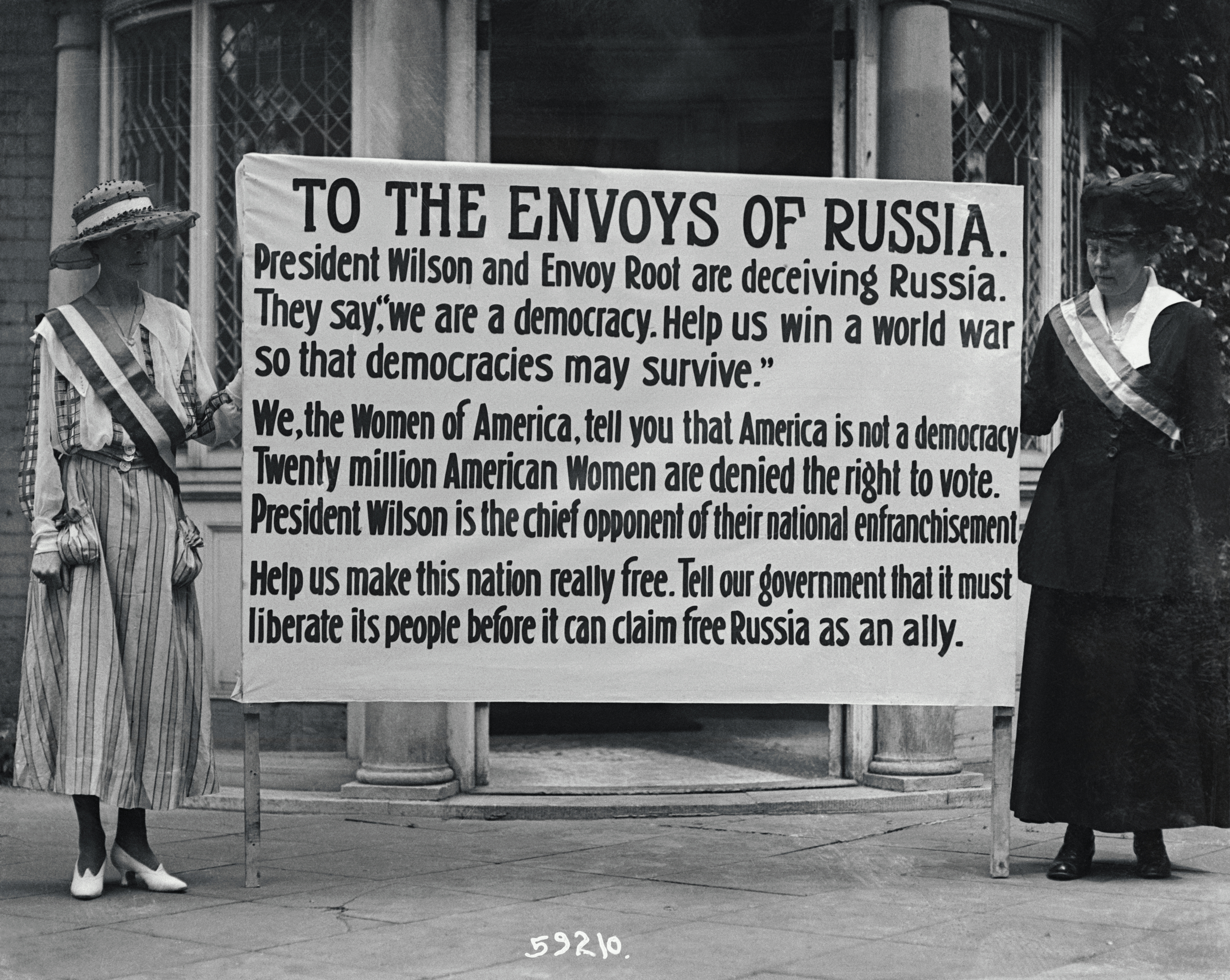 These two suffragettes carried their banner to a White House gate on June 22, 1917. The message indicts Woodrow Wilson, but he later came out in favor of the Nineteenth Amendment. The words "free Russia" refer to the women's voting rights introduced by the provisional regime that had overthrown the Czar in March. (Bettmann—Bettmann Archive)