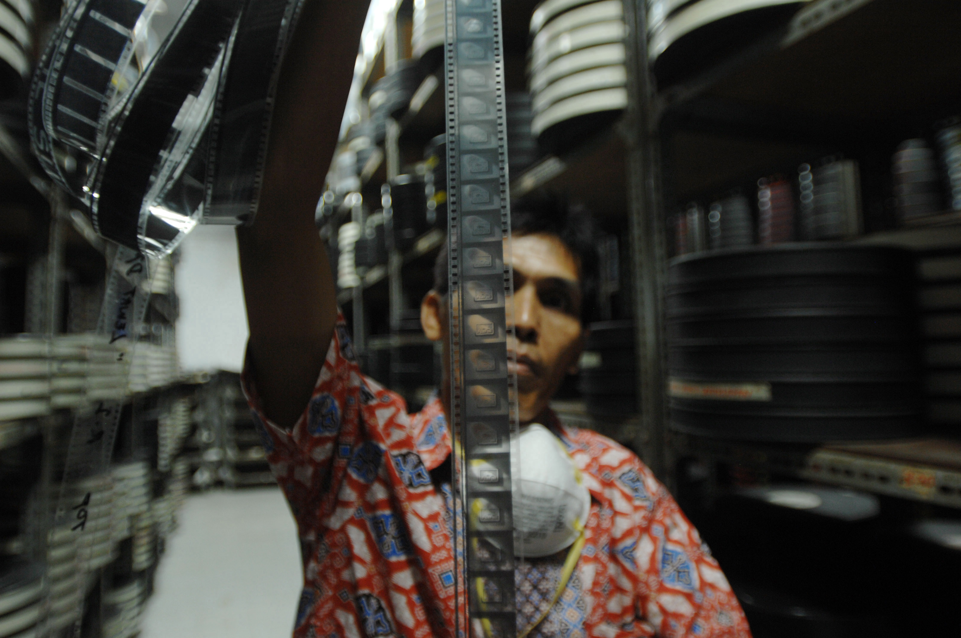 A film archivist holds up a film roll in the storage room at the Usmar Ismail Building in Jakarta, Indonesia on Oct. 28, 2016. (Dasril Roszandi—NurPhoto/Getty Images)