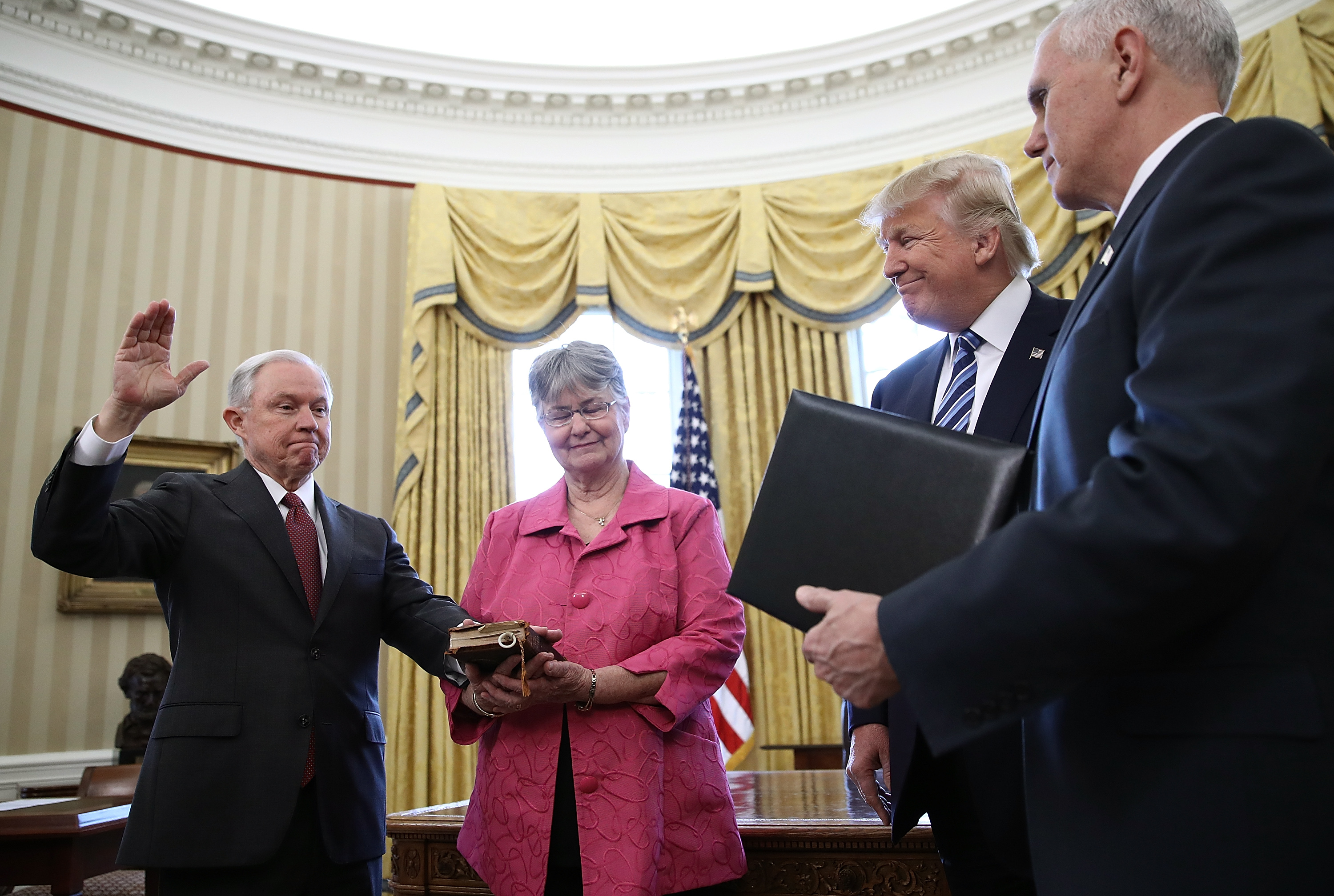 U.S. President Donald Trump (2nd R) watches as Jeff Sessions (L) is sworn in as the new U.S. Attorney General by U.S. Vice President Mike Pence (R) in the Oval Office of the White House February 9, 2017 in Washington, D.C. (Photo by Win McNamee/Getty Images) (Win McNamee&mdash;Getty Images)
