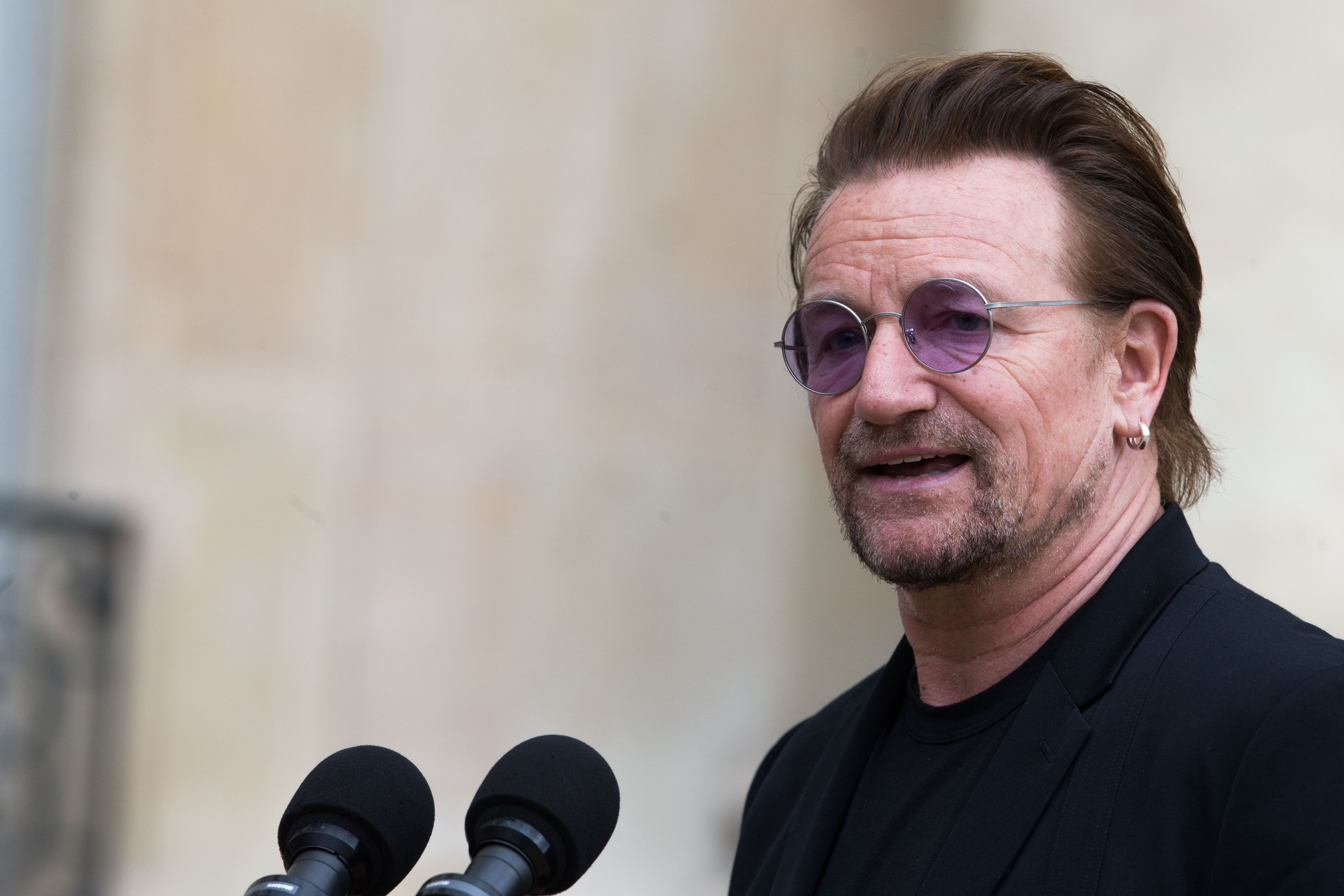 Bono, singer of U2 and cofounder of the NGO One, delivers a speech after his meeting with French President Emmanuel Macron (not pictured) during a press conference at the Elysee Palace on July 24, 2017 in Paris, France. (Nicolas Kovarik/IP3—Getty Images)