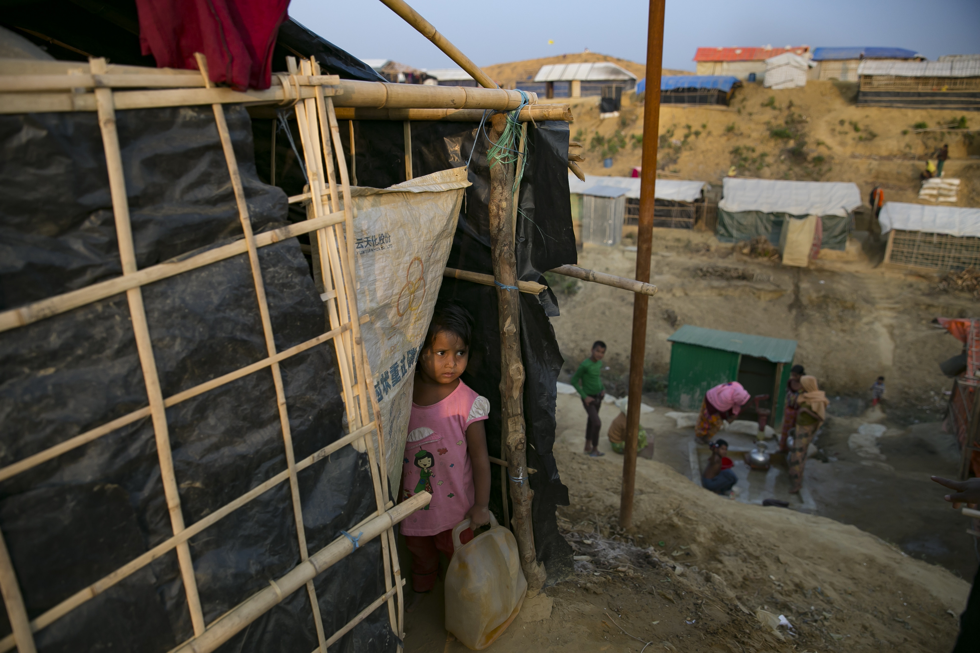 A girl looks out of her tent in the Balukhali refugee camp in Cox's Bazar, Bangladesh on Jan. 17, 2018. U.N. fact finders have pointed to the role that hate speech on social media has played in fueling anti-Rohingya sentiment and violence in Myanmar. (Allison Joyce—Getty Images)
