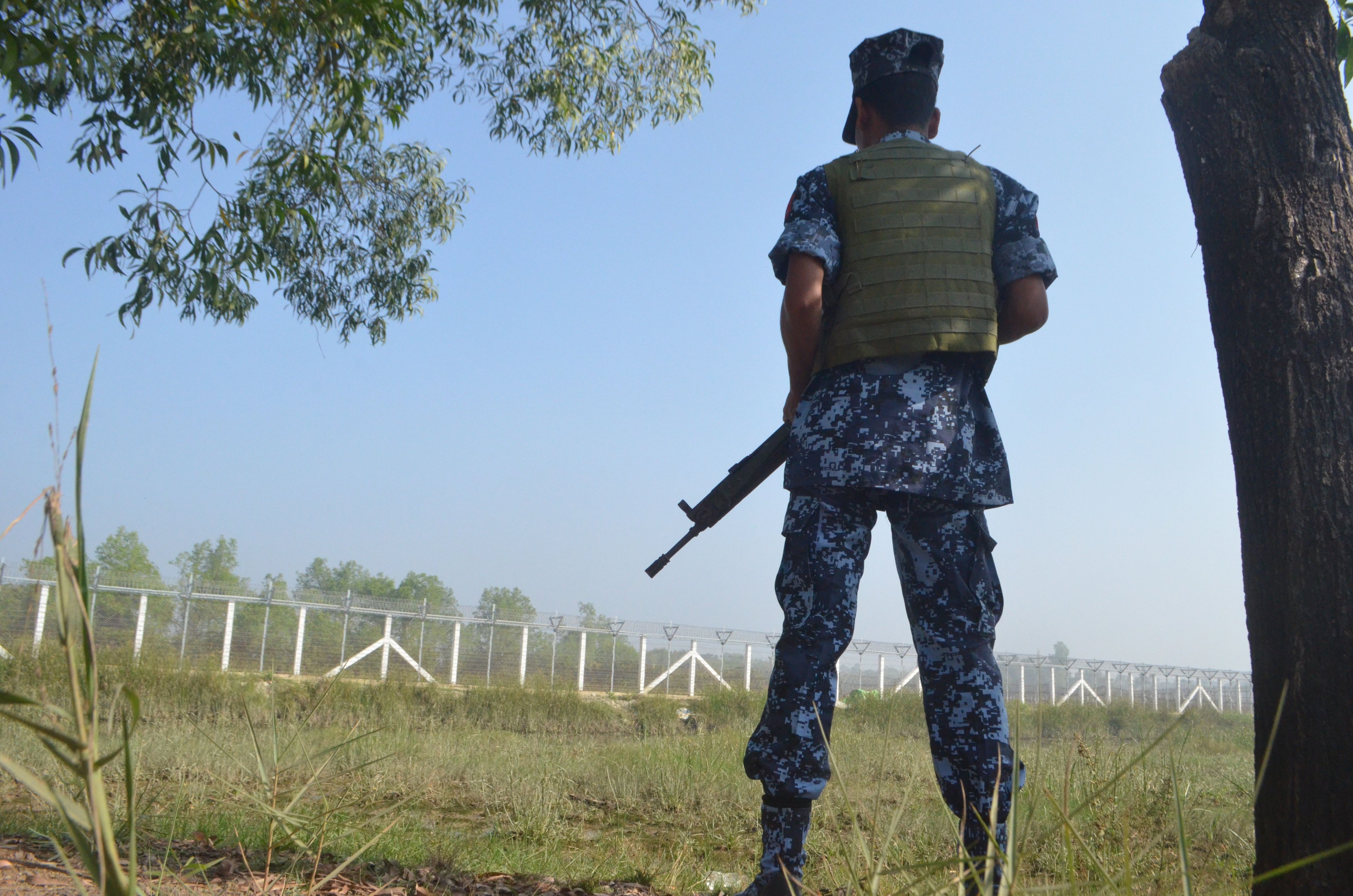A Myanmar border policeman holds his weapon as he stands near the Taungpyo Bangladesh-Myanmar border gate on the outskirts of Maungdaw in Rakhine state on Jan. 24, 2018. (AFP/Getty Images)