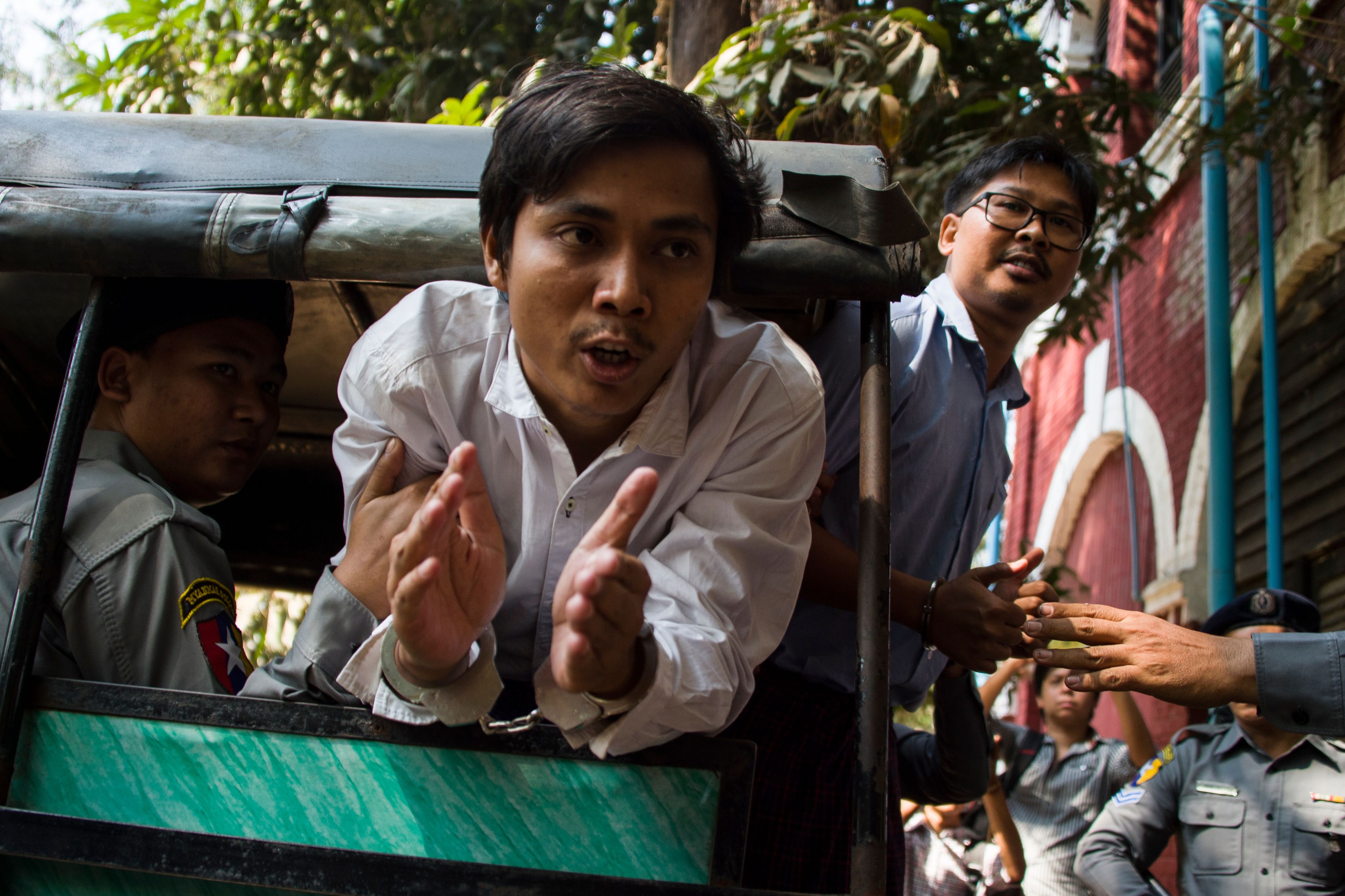 Detained Reuters journalists Kyaw Soe Oo  and Wa Lone talk to the media as they are taken from court in Yangon, Myanmar on Feb. 14, 2018. (Ye Aung Thu—AFP/Getty Images)