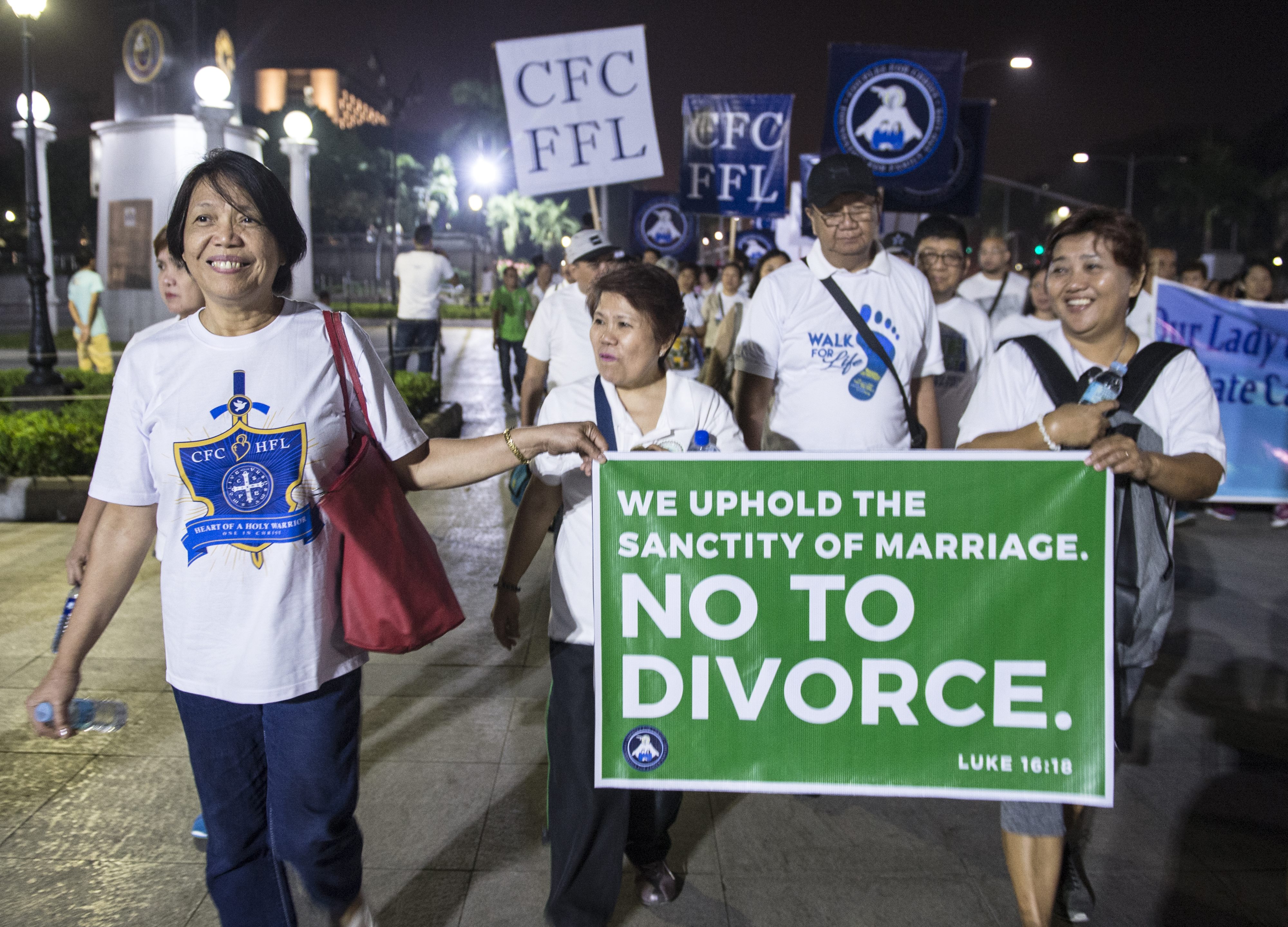 Catholic protestors carry signs at a "march for life" to oppose a bill legalizing divorce in Manila, Philippines on Feb. 24, 2018. (Ted Aljibe—AFP/Getty Images)
