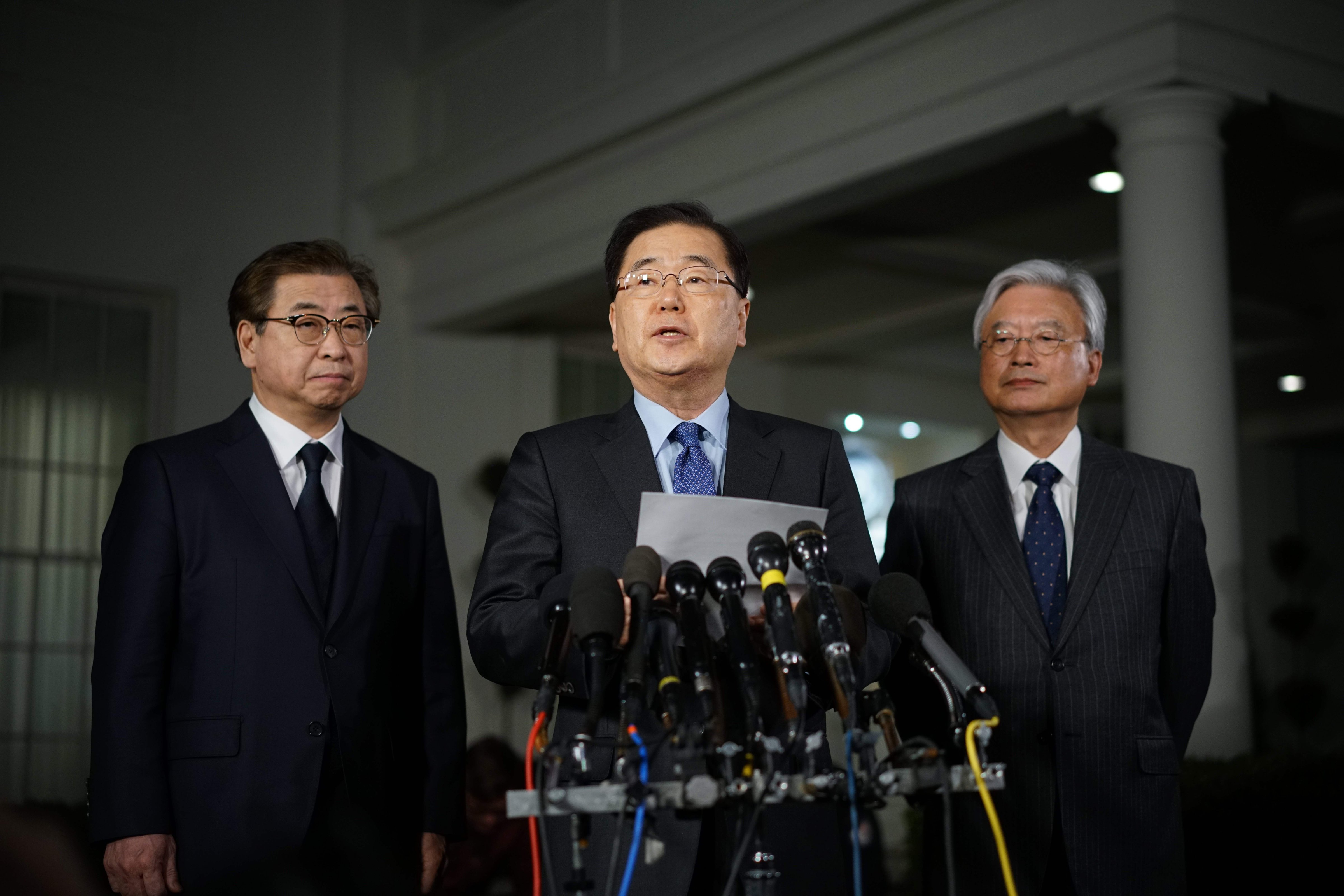 South Korean National Security Advisor Chung Eui-yong flanked by South Korea National Intelligence Service chief Suh Hoon (L) and South Korea's ambassador to the United States Cho Yoon-je (R), outside the West Wing of the White House on March 8, 2018 in Washington, DC. (Mandel Ngan—AFP/Getty Images)