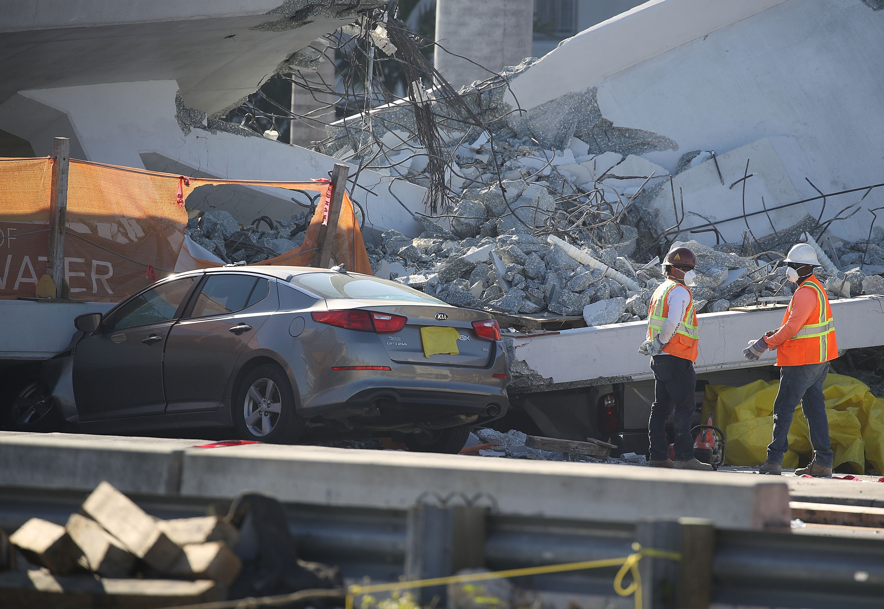 Workers, law enforcement and members of the National Transportation Safety Board investigate the scene where a pedestrian bridge collapsed a few days after it was built over southwest 8th street allowing people to bypass the busy street to reach Florida International University on March 16, 2018 in Miami, Florida. (Joe Raedle—Getty Images)