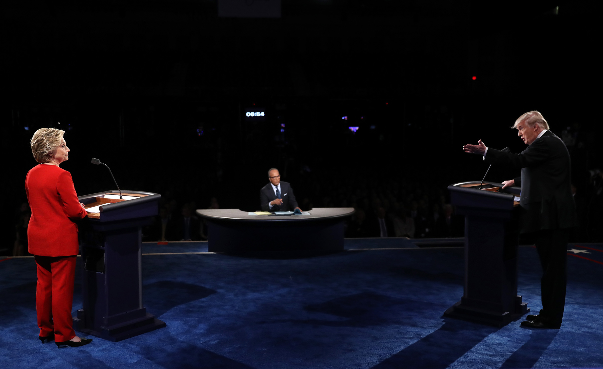 Republican presidential nominee Donald Trump speaks as Democratic presidential nominee Hillary Clinton and Moderator Lester Holt listens during the Presidential Debate at Hofstra University on Sept. 26, 2016. (Joe Raedle—Getty Images)