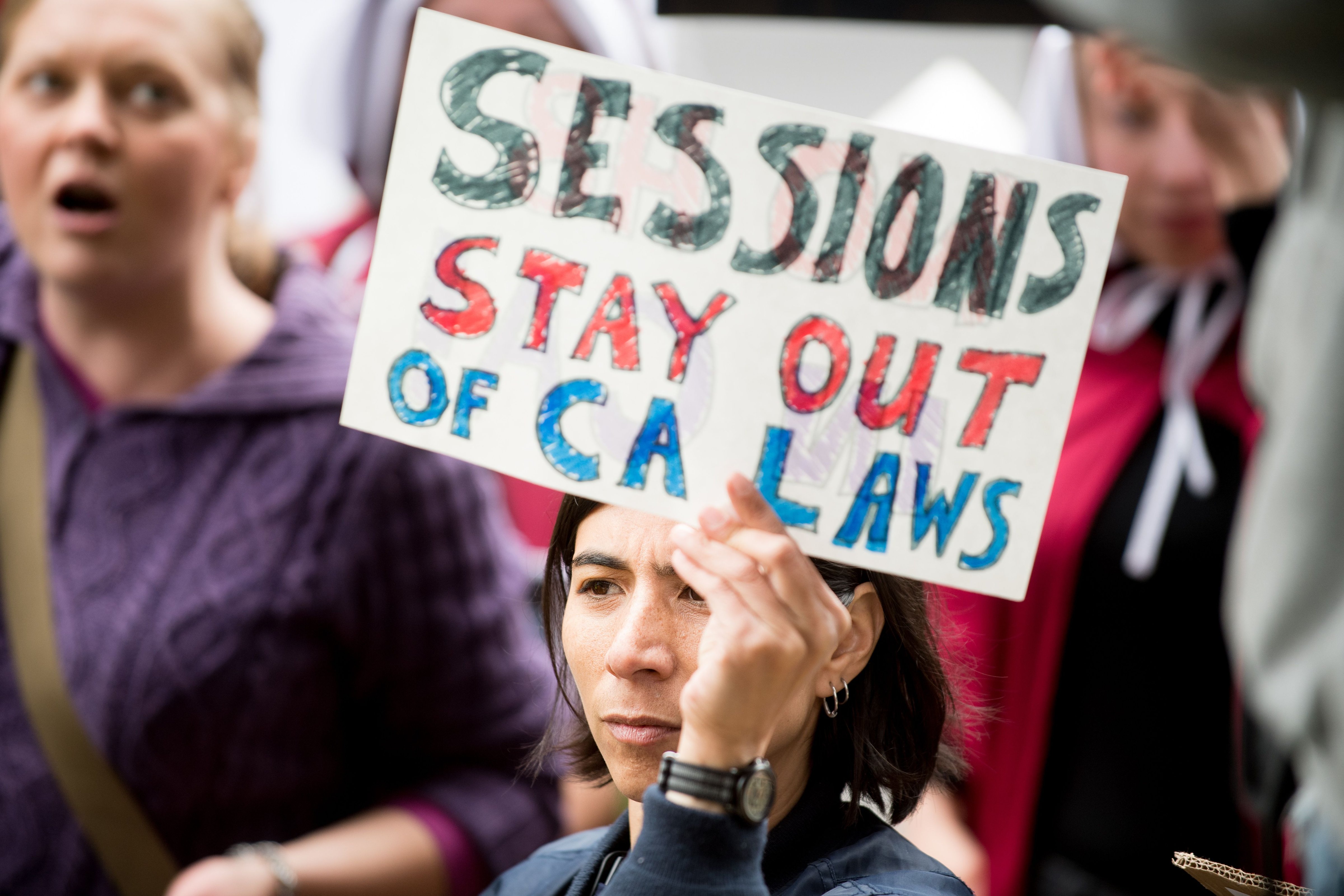 A protestor outside a speech by U.S. Attorney General Jeff Sessions on March 7, 2018, in Sacramento (Noah Berger—AFP/Getty Images)