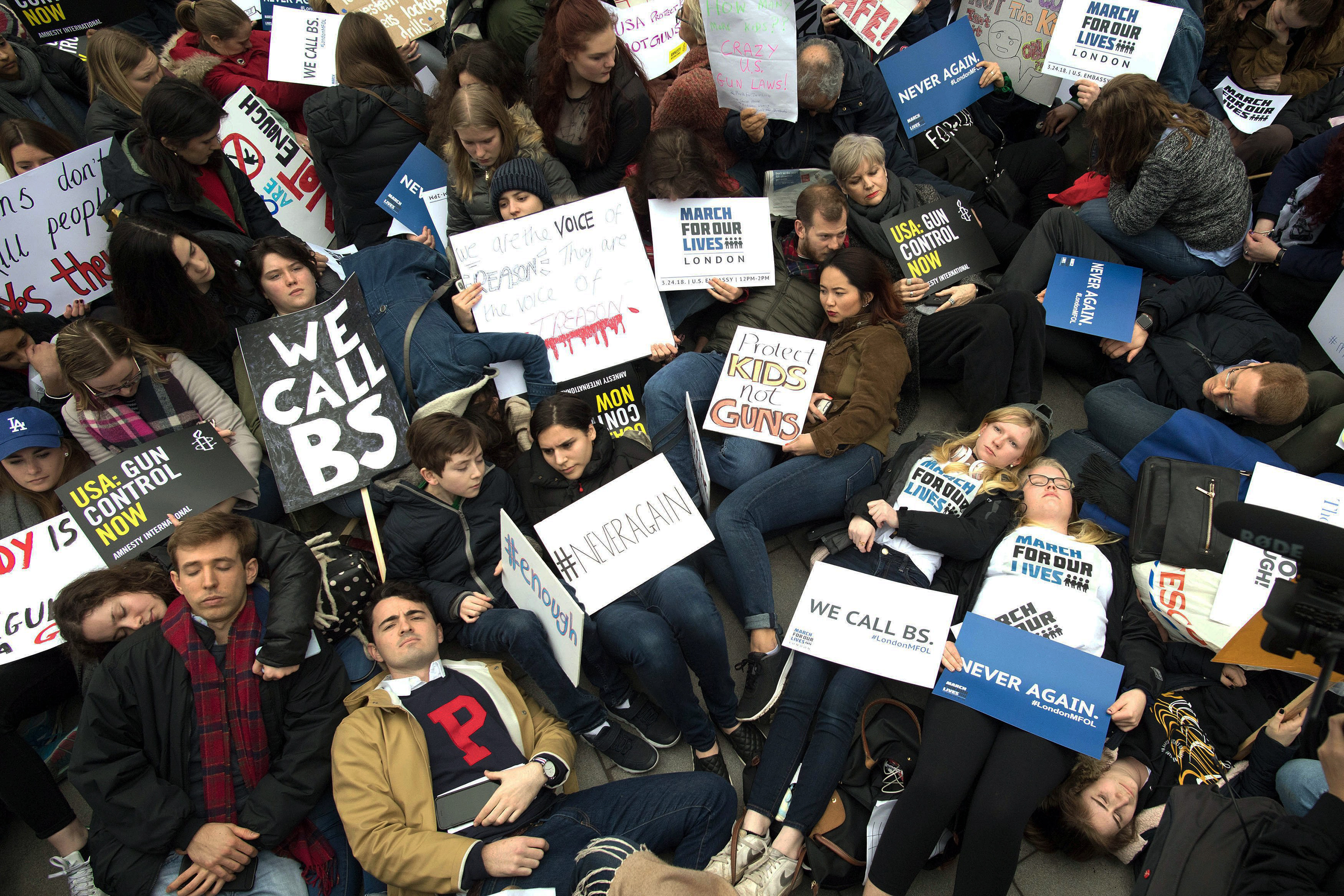 Protesters staged a 'die-in' during the March For Our Lives rally outside the U.S. Embassy in London. (Stefan Rousseau—PA Wire)