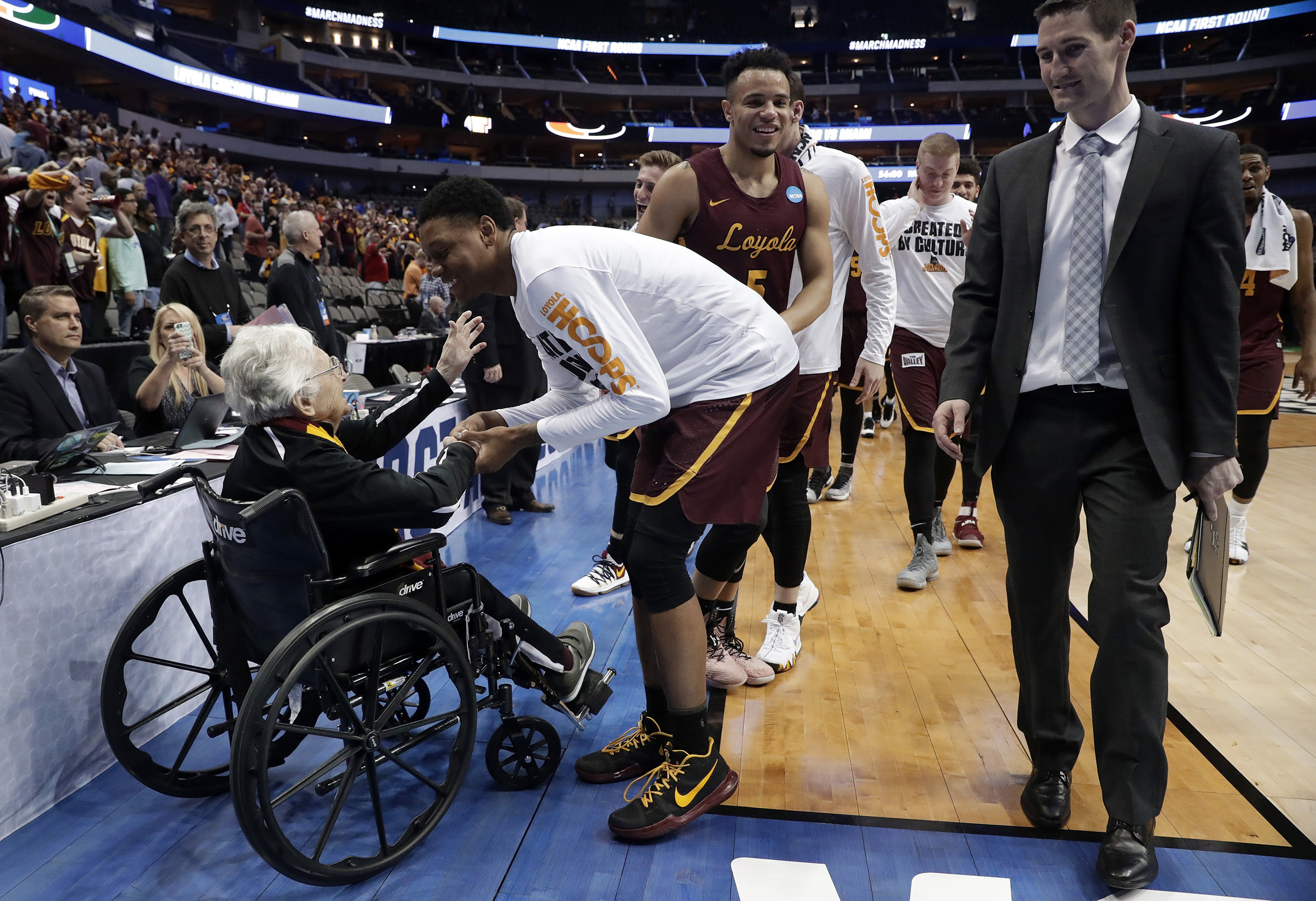 Sister Jean, the 98-year-old team chaplain for Loyola-Chicago, greets players after a win (Tony Gutierrez—AP/Shutterstock)