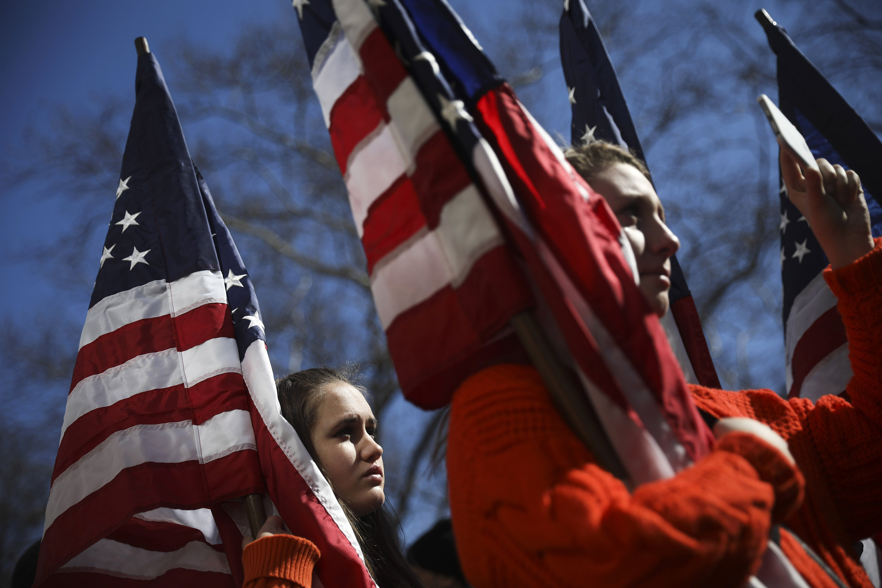 High school students from New Jersey hold American flags as they attend the March For Our Lives near Columbus Circle. (Drew Angerer—Getty Images)