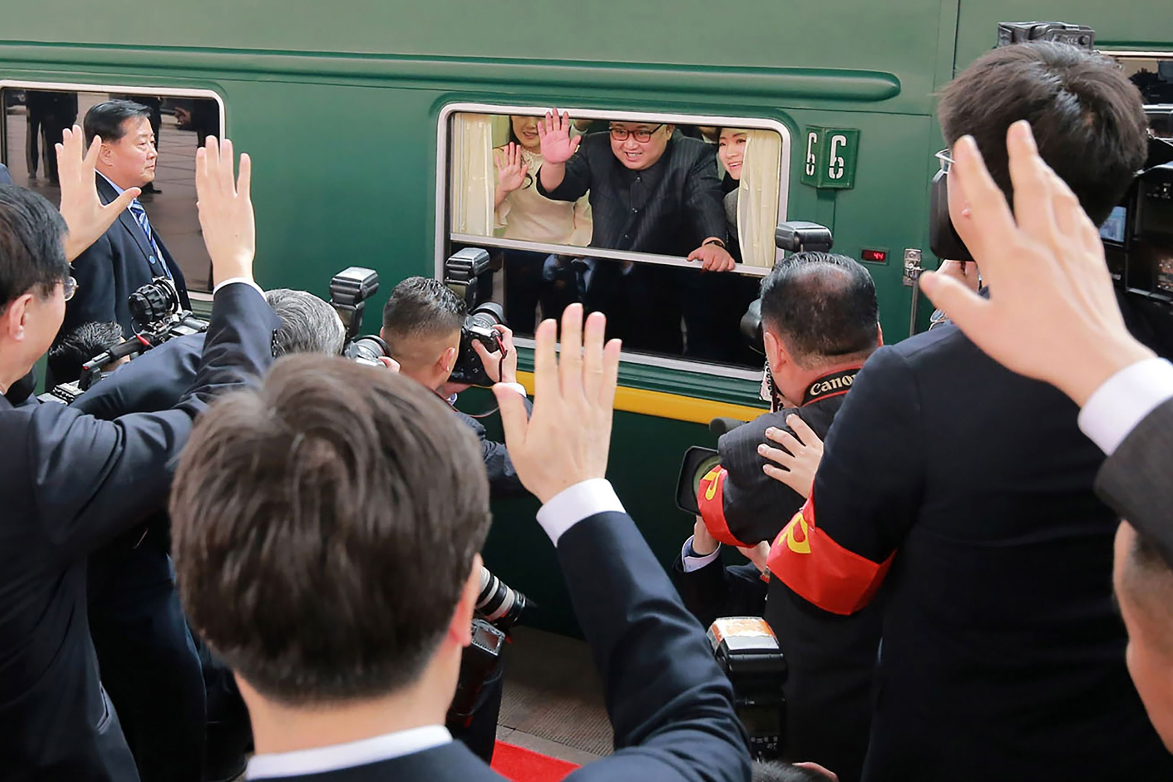 North Korean leader Kim Jong Un waves from his train as it prepares to depart from Beijing railway station (KCNA/KNS/AFP/Getty Images)