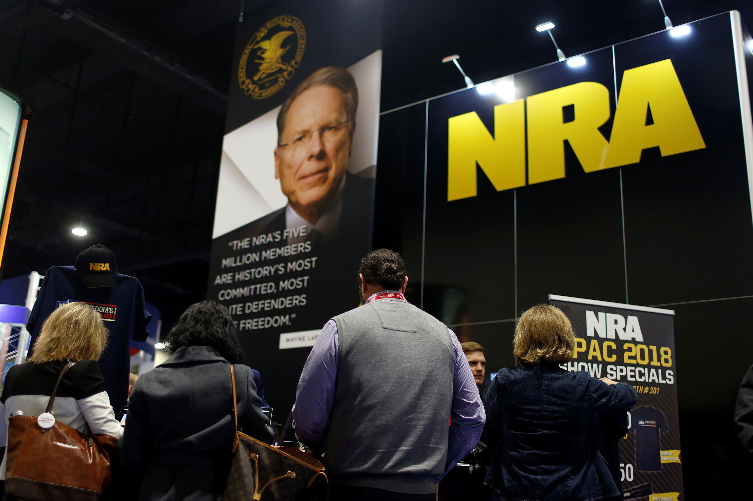People sign up at the booth for the National Rifle Association (NRA) at the Conservative Political Action Conference (CPAC) at National Harbor, Maryland