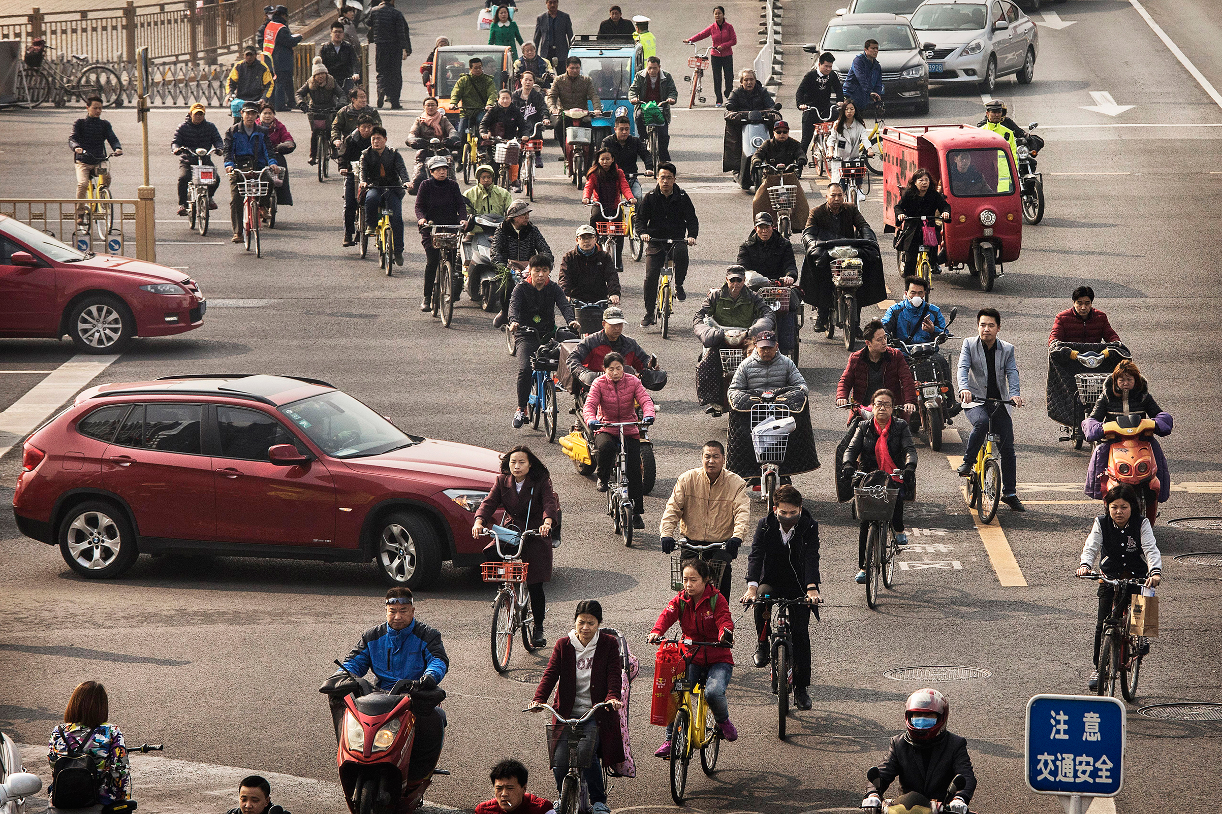 Chinese commuters ride bike shares and other modes of transport in the bicycle lane during rush hour in Beijing on March 29, 2017. (Kevin Frayer—Getty Images)