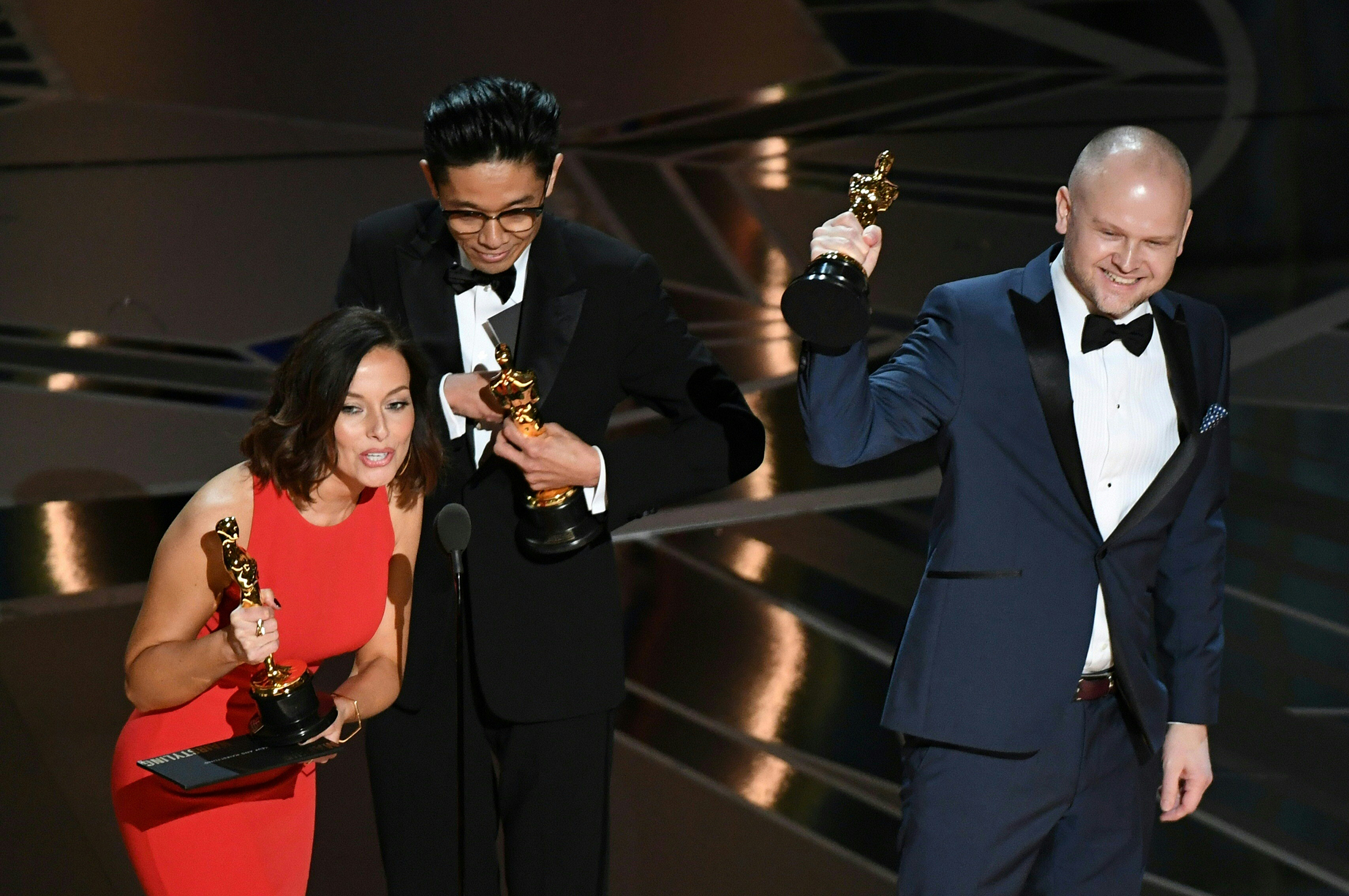 Make-Up and Hairstyling artists Lucy Sibbick, Kazuhiro Tsuji and David Malinowski accept the Oscar for Best Makeup and Hairstyling in Darkest Hour during the 90th Annual Academy Awards show on March 4, 2018 in Hollywood. (Mark Ralston—AFP/Getty Images)