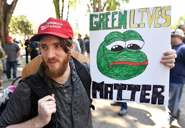 Andrew Knight holds a sign of Pepe the frog, a conservative icon, during a rally in Berkeley, California on April 27, 2017. (JOSH EDELSON/AFP/Getty Images)