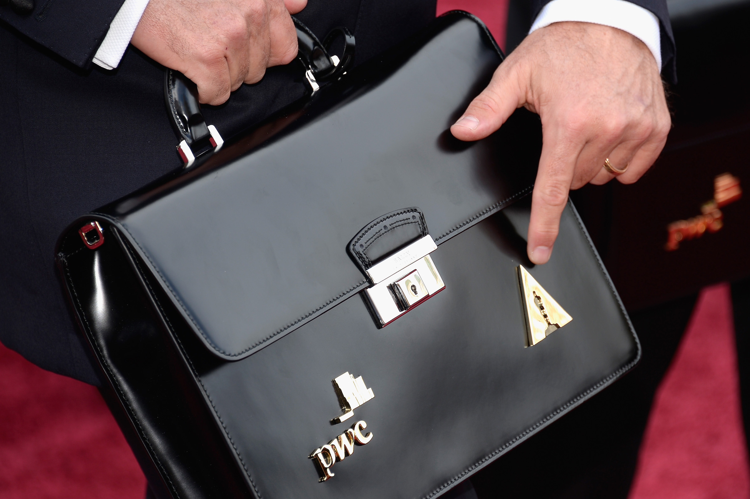 A PricewaterhouseCoopers representative (with a briefcase) attends the Oscars held on March 2, 2014 in Hollywood, Calif. (Kevork Djansezian—Getty Images)