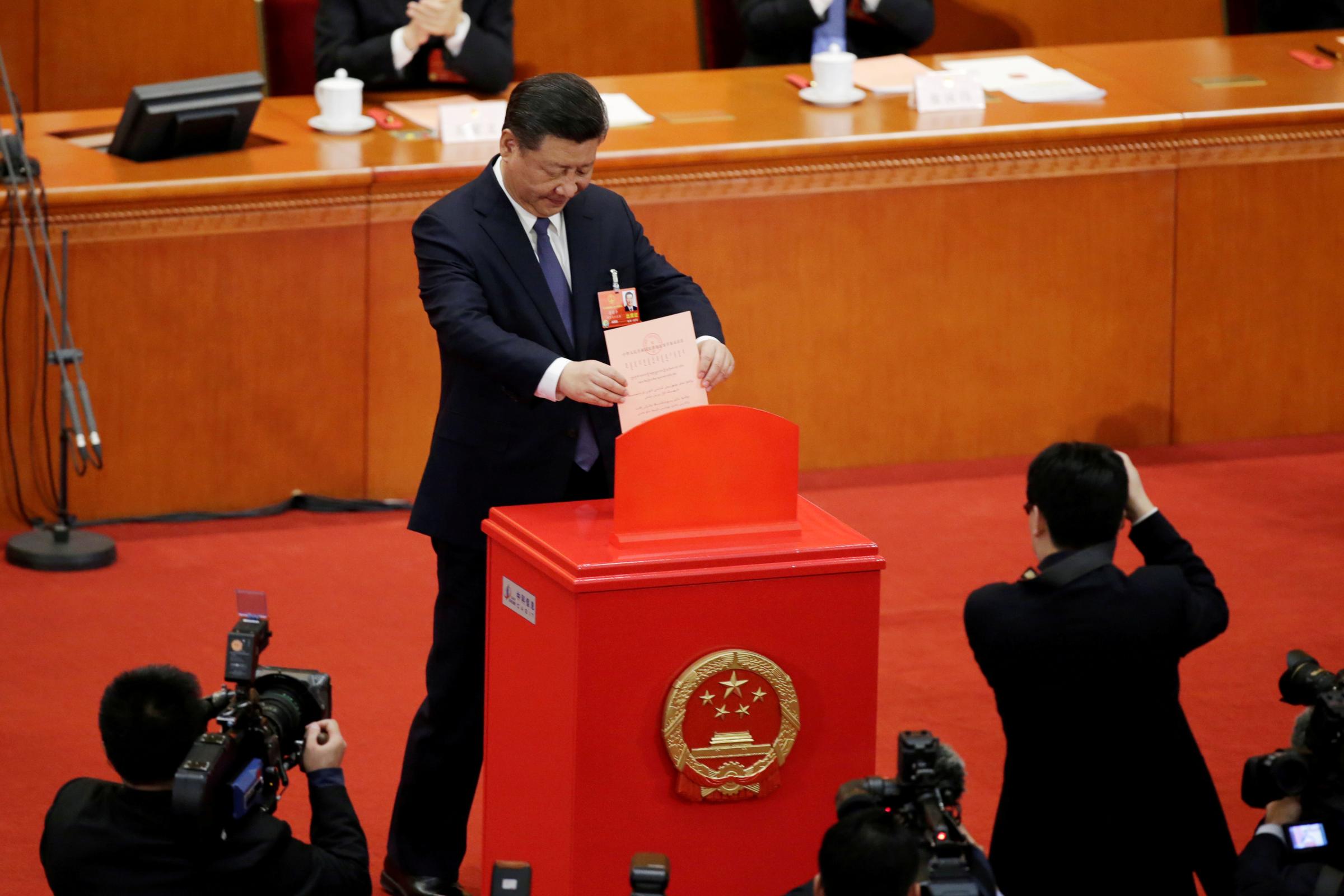 Chinese President Xi Jinping drops his ballot at the third plenary session of the National People's Congress (NPC) at the Great Hall of the People in Beijing