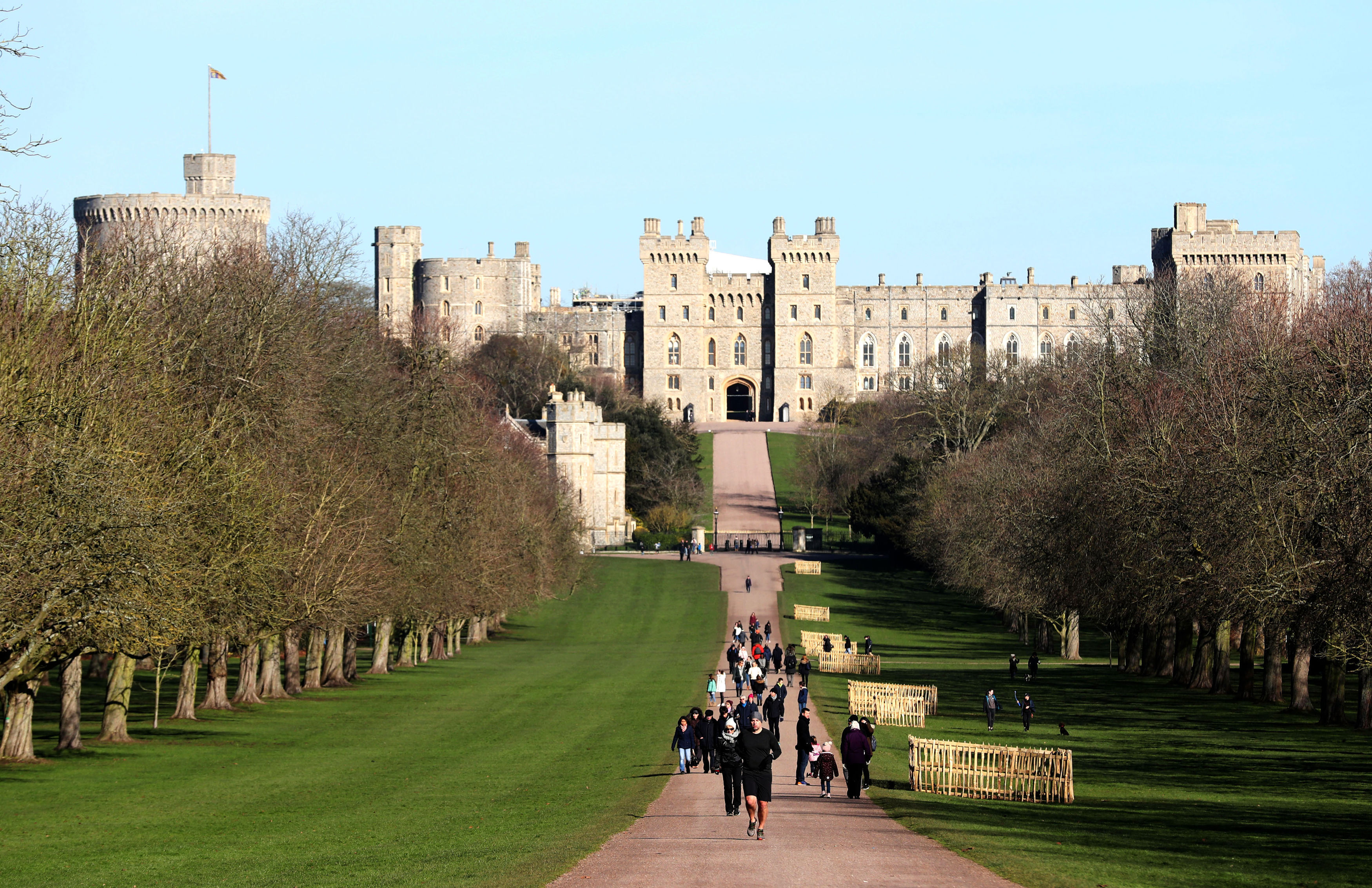 Blue skies over Windsor Castle in Berkshire, as people walk along the Long Walk. Steve Parsons - PA Images—Getty Images (Steve Parsons - PA Images—Getty Images)