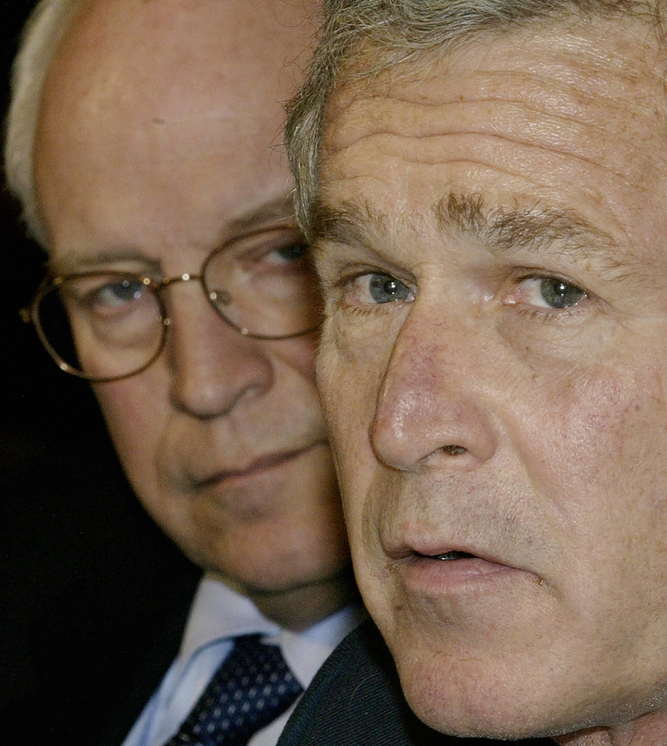President George W. Bush speaks to reporters during a meeting with economists in the Roosevelt Room of The White House as Vice President Dick Cheney looks on in Washington, on Jan. 30, 2004. (Luke Frazza—AFP/Getty Images)
