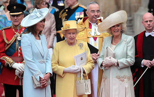 Queen Elizabeth II is flanked by Carole Middleton (left)and Camilla, Duchess of Cornwall after the wedding ceremony Prince William and Kate Middleton at Westminster Abbey. (Lewis Whyld - PA Images—PA Images via Getty Images)