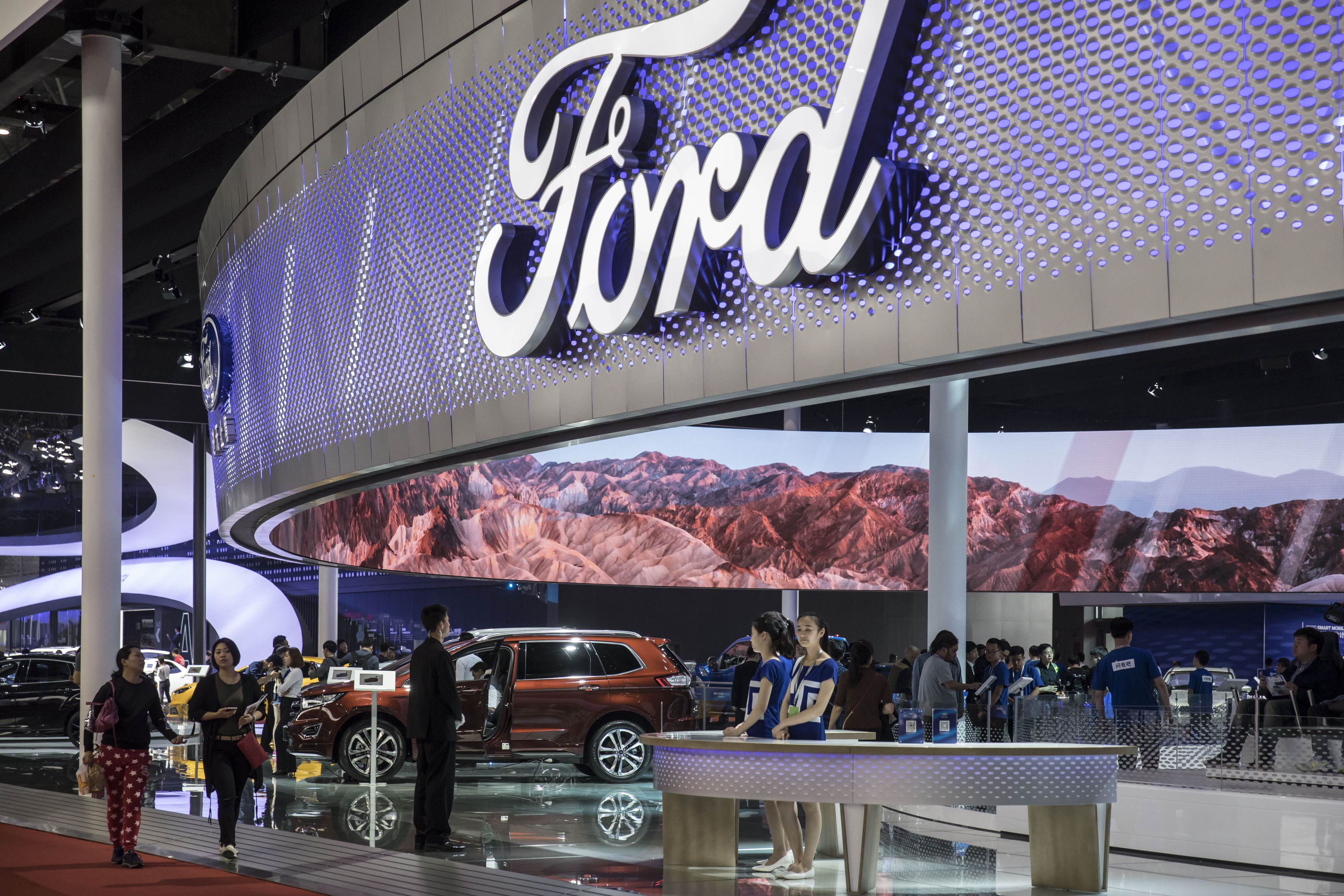 Attendees walk in the Ford Motor Co. display area at the Auto Shanghai 2017 vehicle show in Shanghai, China, on Thursday, April 20, 2017. (Qilai Shen/Bloomberg via Getty Images)