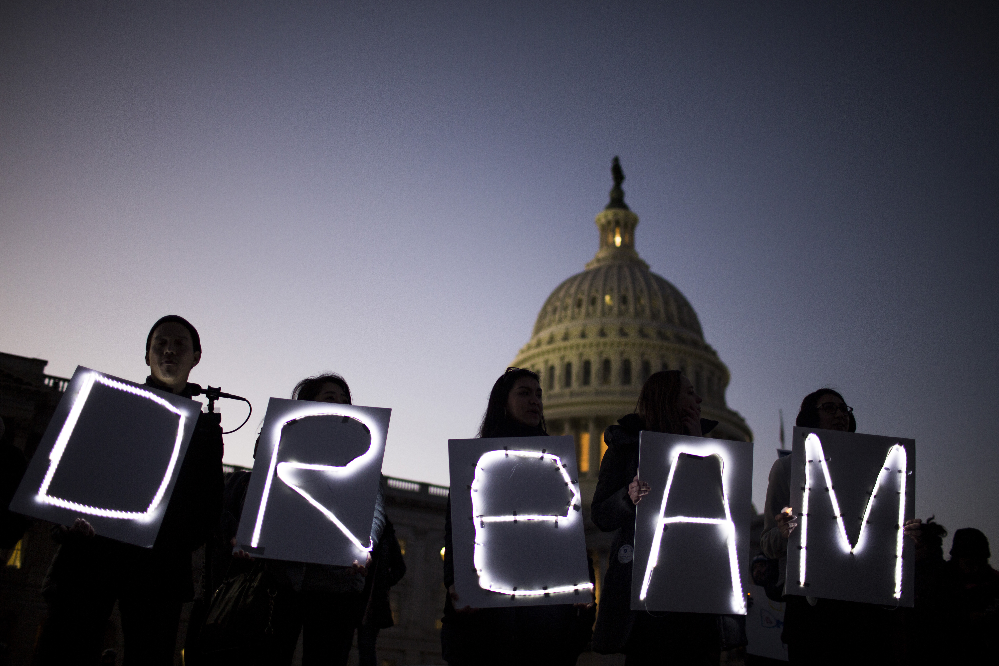Demonstrators hold illuminated signs during a rally supporting the Deferred Action for Childhood Arrivals program (DACA), or the Dream Act, outside the U.S. Capitol building in Washington, D.C., U.S., on Jan. 18, 2018. (Zach Gibson—Bloomberg/Getty Images)