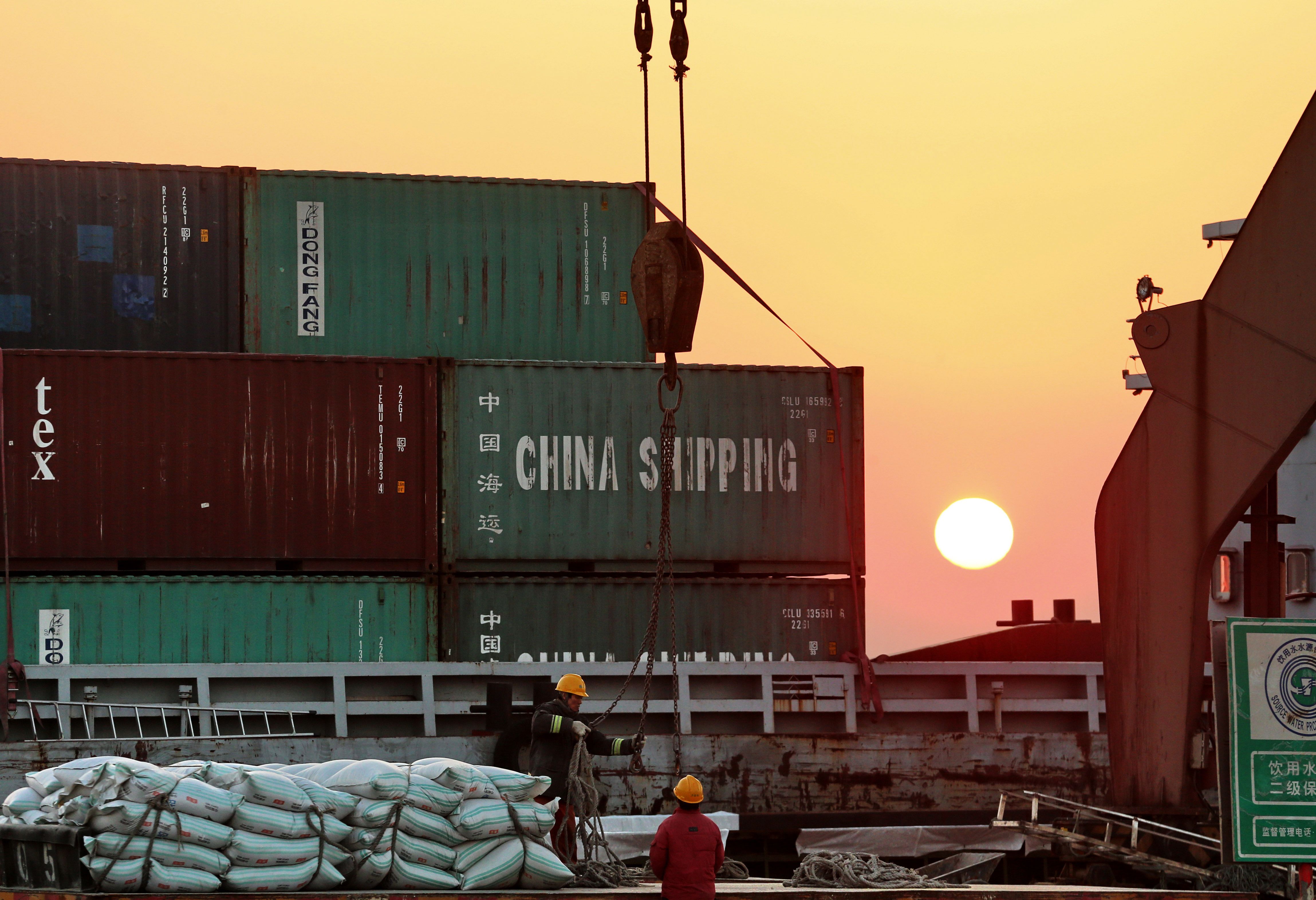 Workers loading ships at a port in Nantong, in China's eastern Jiangsu province, on March 9, 2018. (AFP/Getty Images)