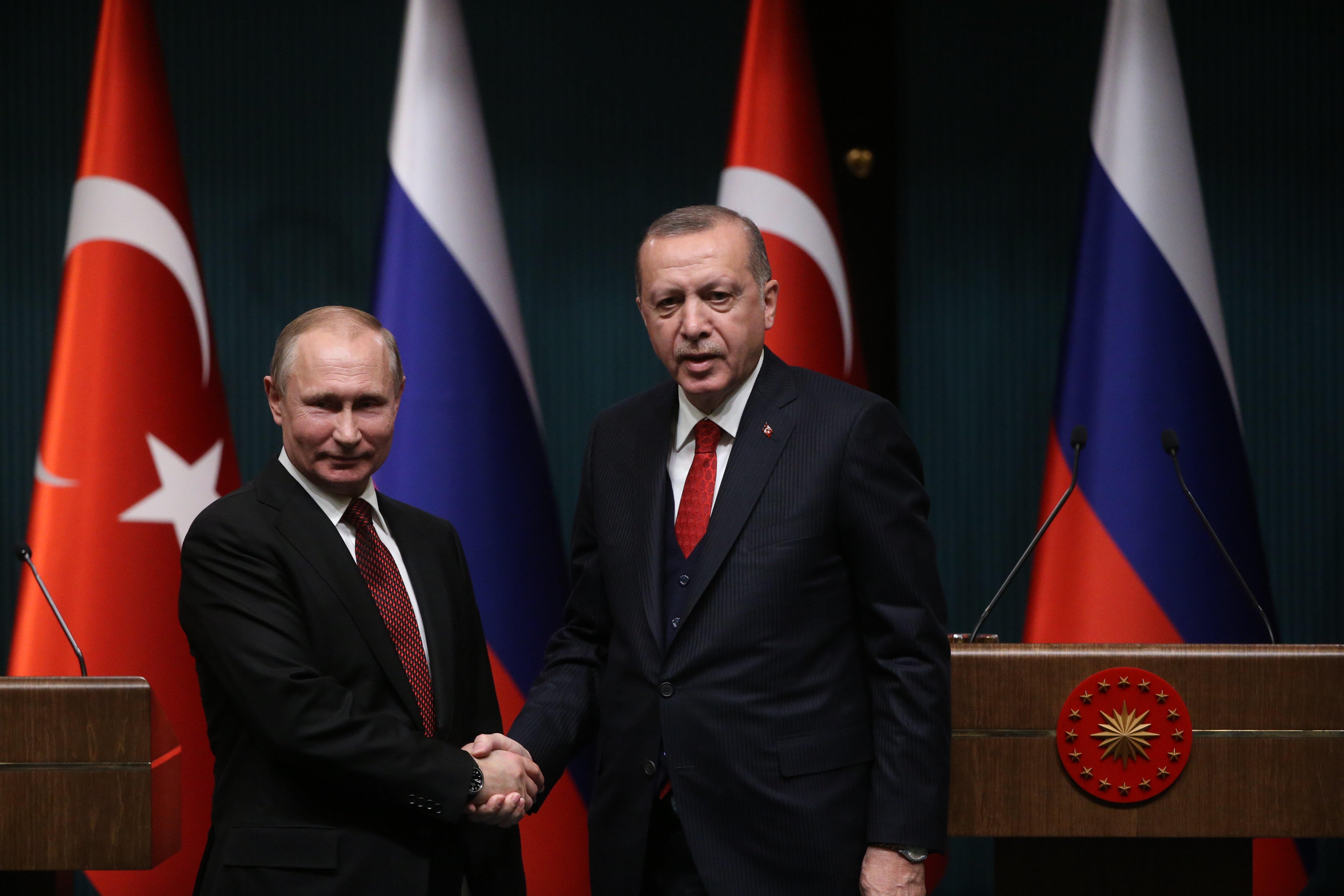Russian President Vladimir Putin shakes hands with Turkish President Recep Tayyip Erdogan during their joint press conference at the presidential palace on April 3, 2018 in Ankara, Turkey. (Mikhail Svetlov—Getty Images)