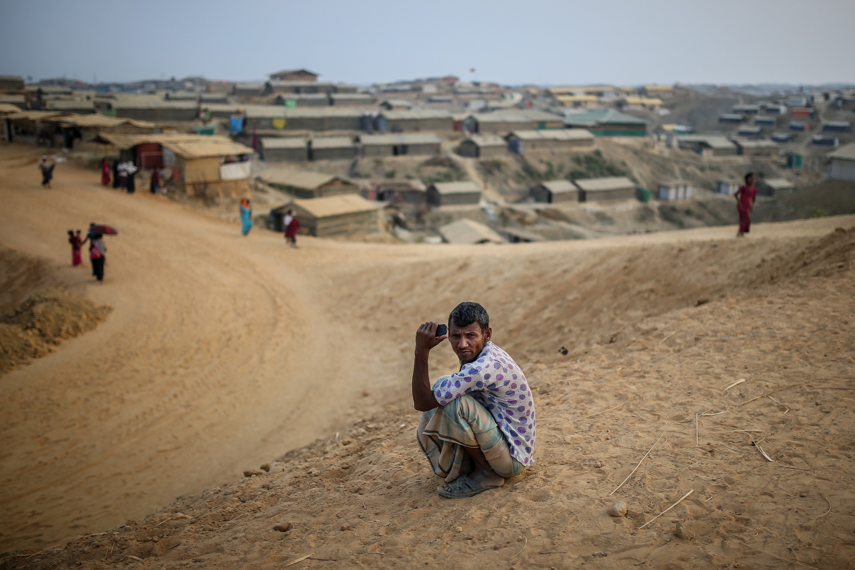 A Rohingya man sits on the ground in the at Kutupalong refugee camp near Cox's Bazar, Bangladesh on April 7, 2018. (Arif Hudaverdi Yaman—Anadolu Agency/Getty Images)