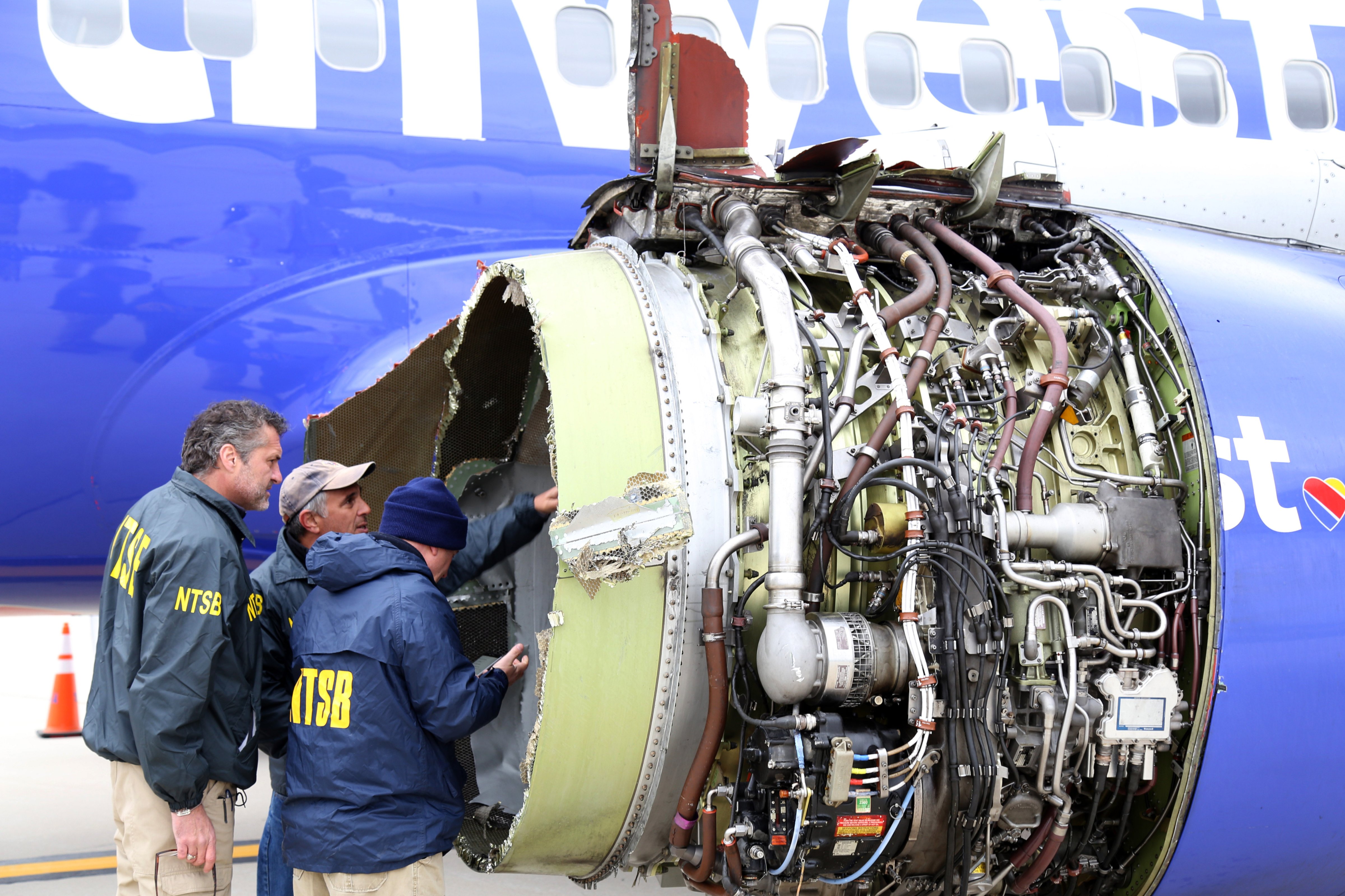 NTSB investigators examine damage to the turbofan engine belonging Southwest Airlines Flight 1380 that separated during flight on April 17, 2018 in Philadelphia, Pennsylvania. (Keith Holloway—National Transportation Safety Board Handout/Getty Images)