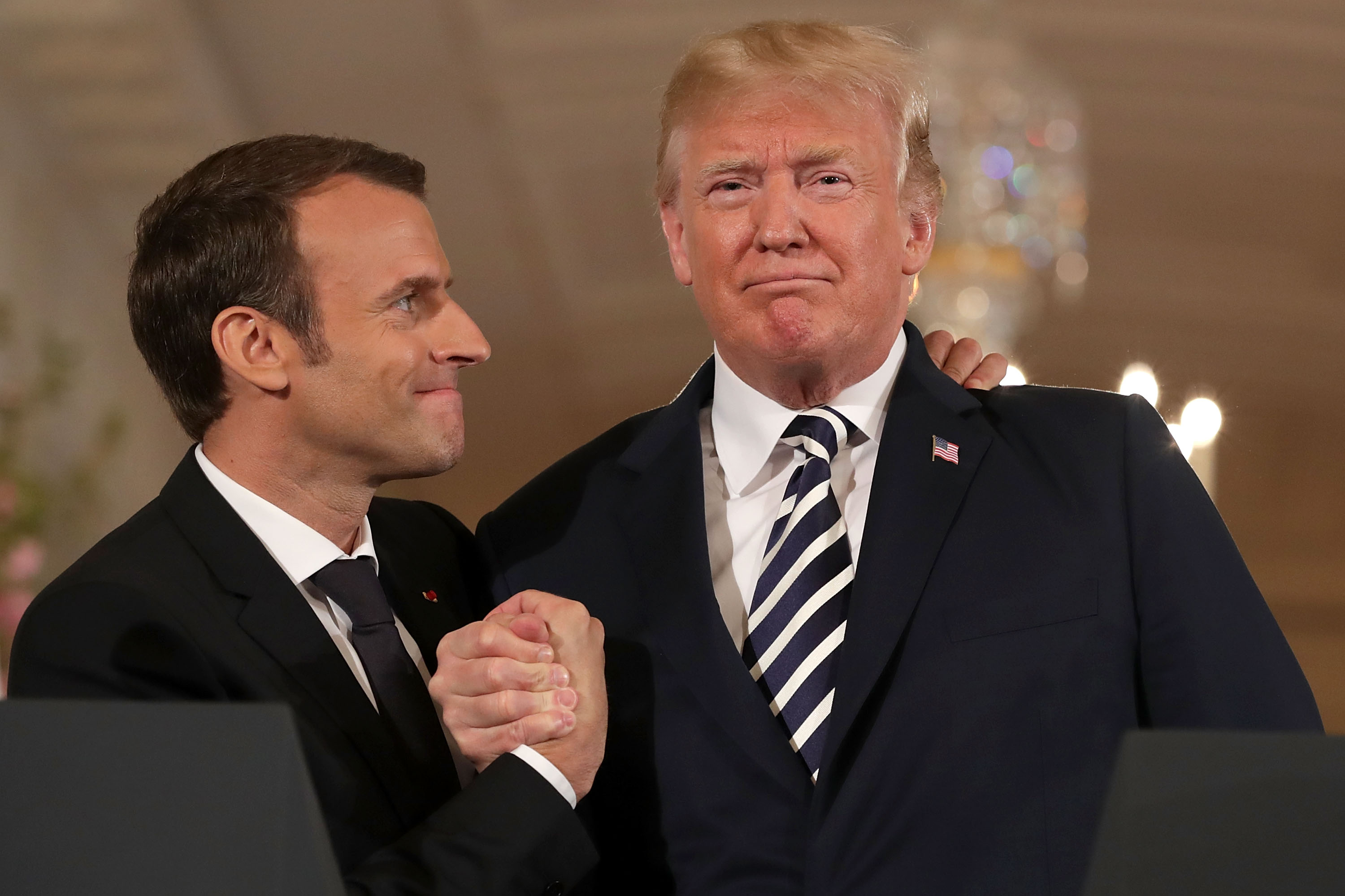 French President Emmanuel Macron (L) and U.S. President Donald Trump embrace at the completion of a joint press conference in the East Room of the White House in Washington, DC April 24, 2018. (Chip Somodevilla—Getty Images)