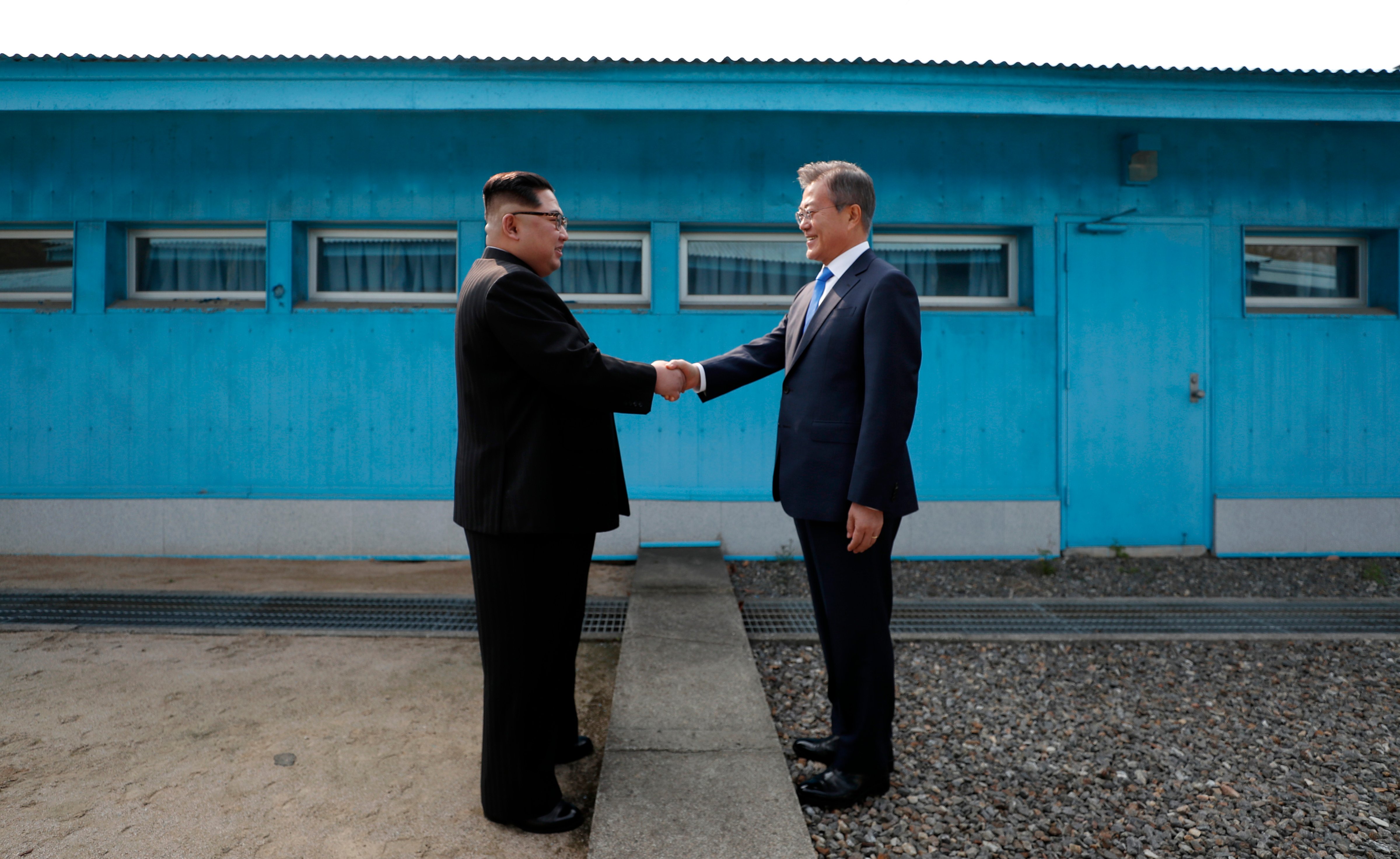 North Korea's leader Kim Jong Un shakes hands with South Korea's President Moon Jae-in at the Military Demarcation Line that divides their countries ahead of their summit at the truce village of Panmunjom on April 27, 2018. (Korea Summit Press Pool&mdash;AFP/Getty Images)