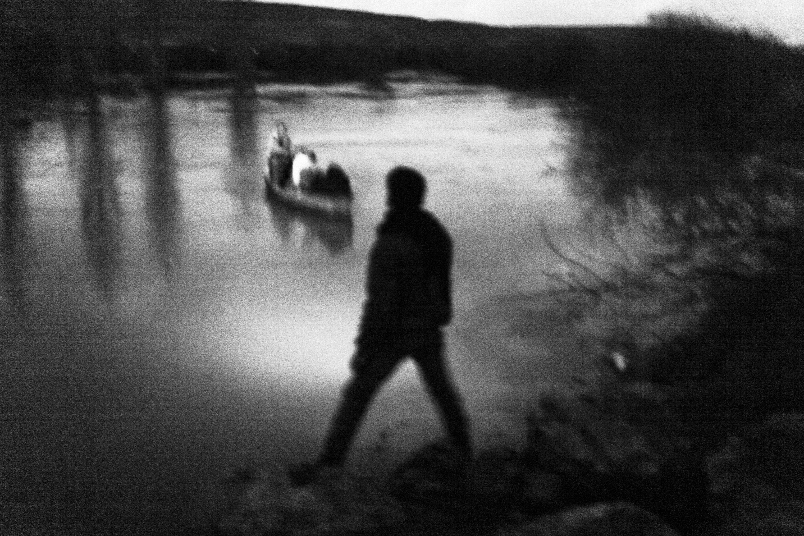 Along the Turkish-Syrian border under the cover of night, a network of Syrian smugglers transport a family fleeing the violence inside Syria on a rowboat across the Orontes River, which marks a stretch of the border between northern Syria and southern Turkey. (Moises Saman—Magnum Photos)