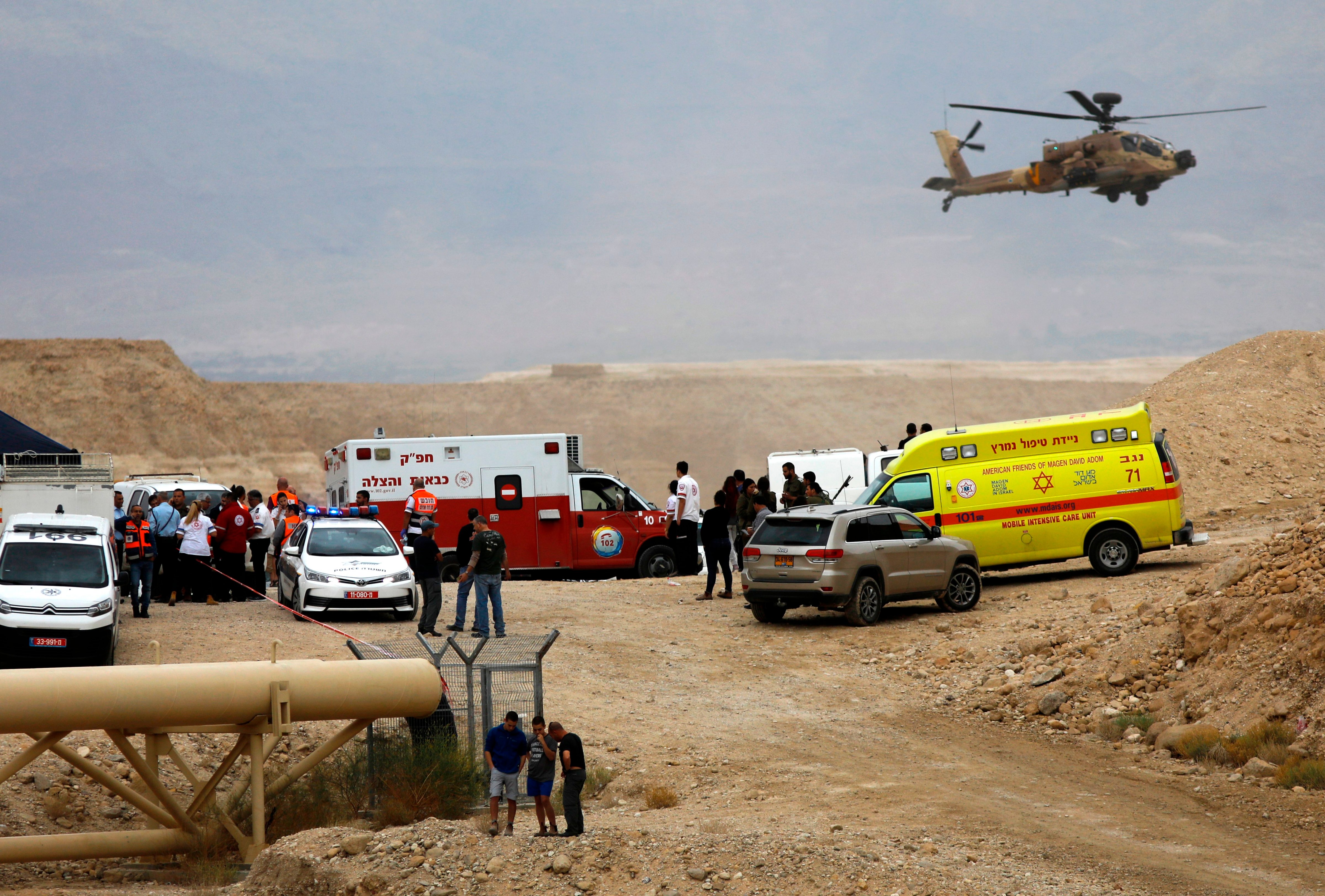 Israeli emergency services take part in a search mission for several young people missing near Arava in southern Israel after flash floods swept through the area while they were hiking near the Dead Sea on April 26, 2018. (MENAHEM KAHANA—AFP/Getty Images)