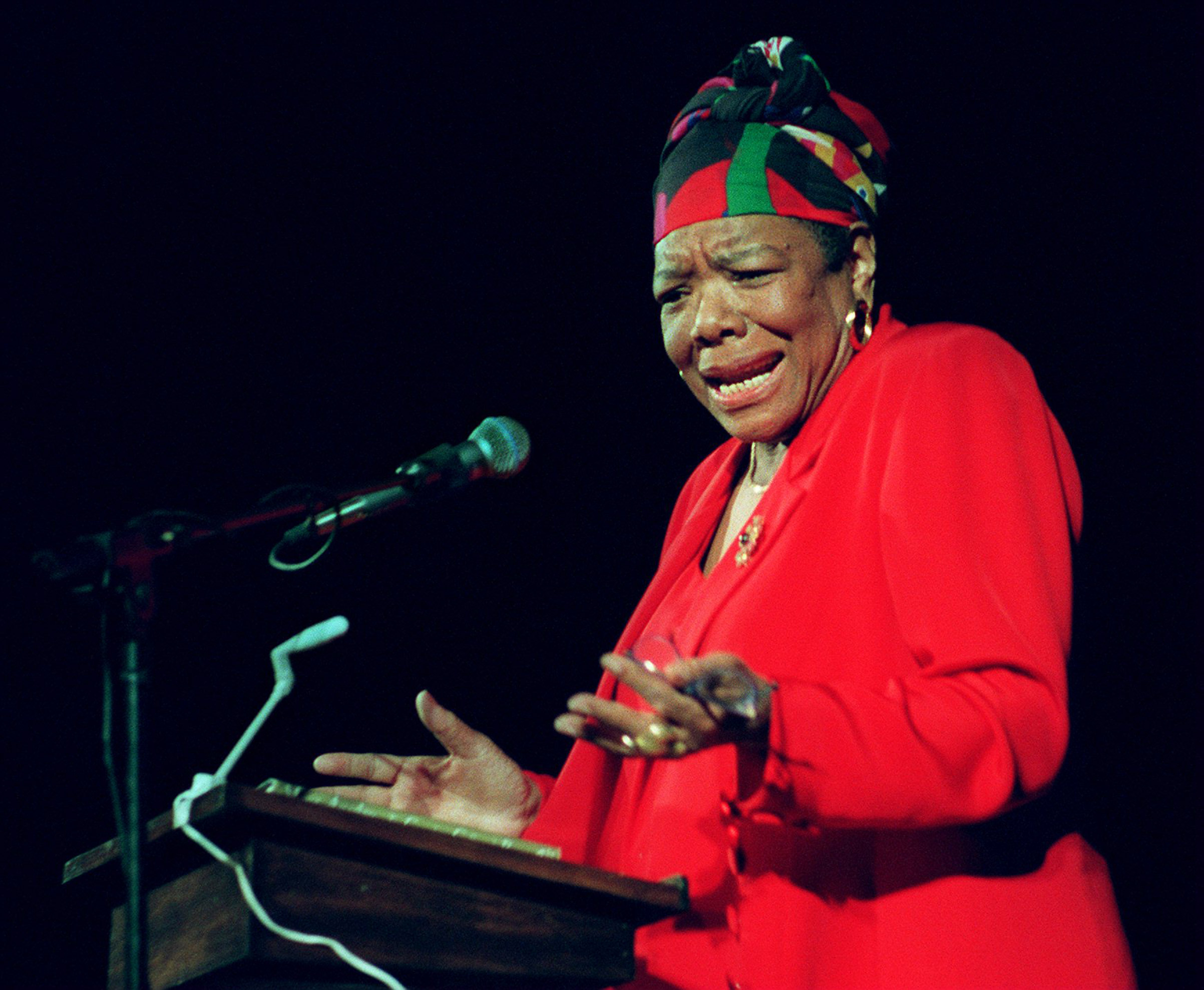 Maya Angelou reads poetry to Tufts University students at the Somerville Theatre in Somerville, Mass. on April 28, 1997. (John Bohn/The Boston Globe—Getty Images)
